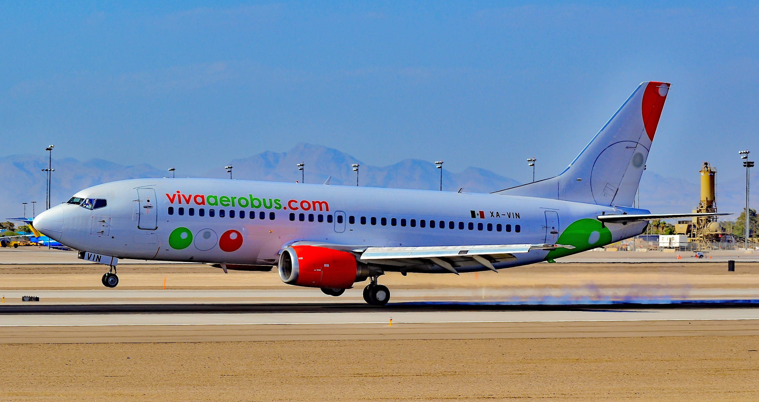 Viva Aerobus, red green and white livery, sunlit airport tarmac, 2K Desktop Wallpaper