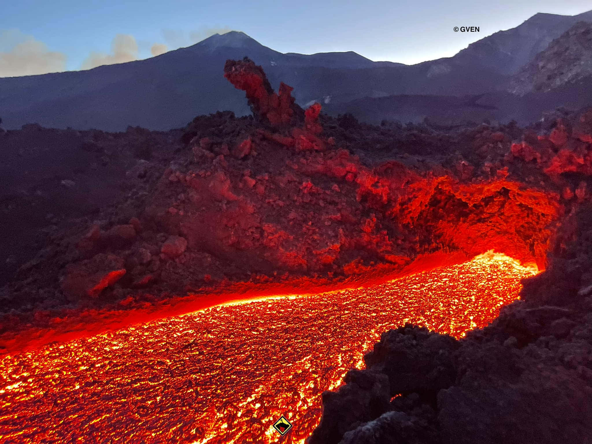 effusive river of lava, glowing red lava, rugged volcanic terrain, Full HD Desktop Wallpaper