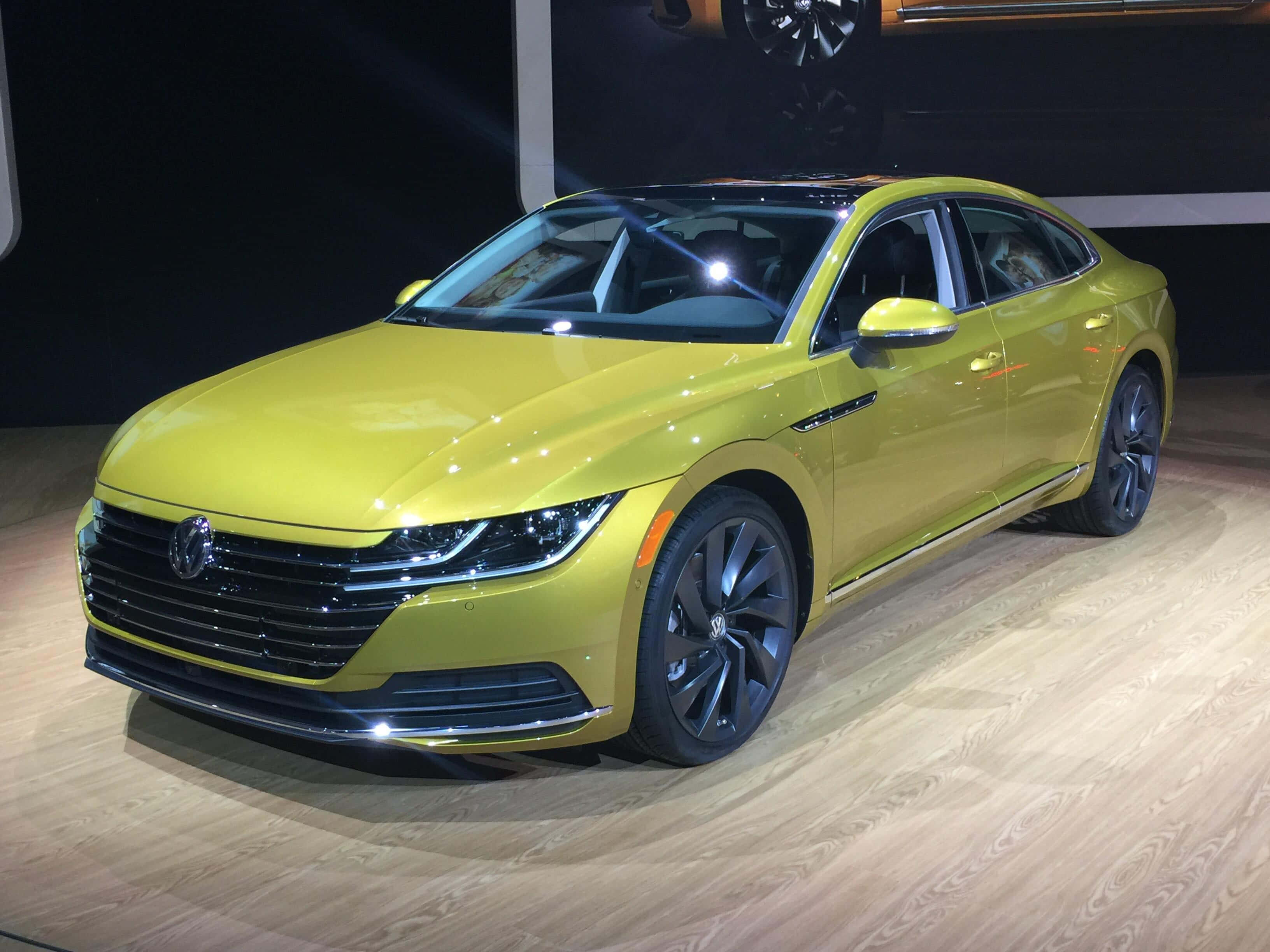 Volkswagen Arteon, yellow, wooden showroom floor, 2K Desktop Wallpaper