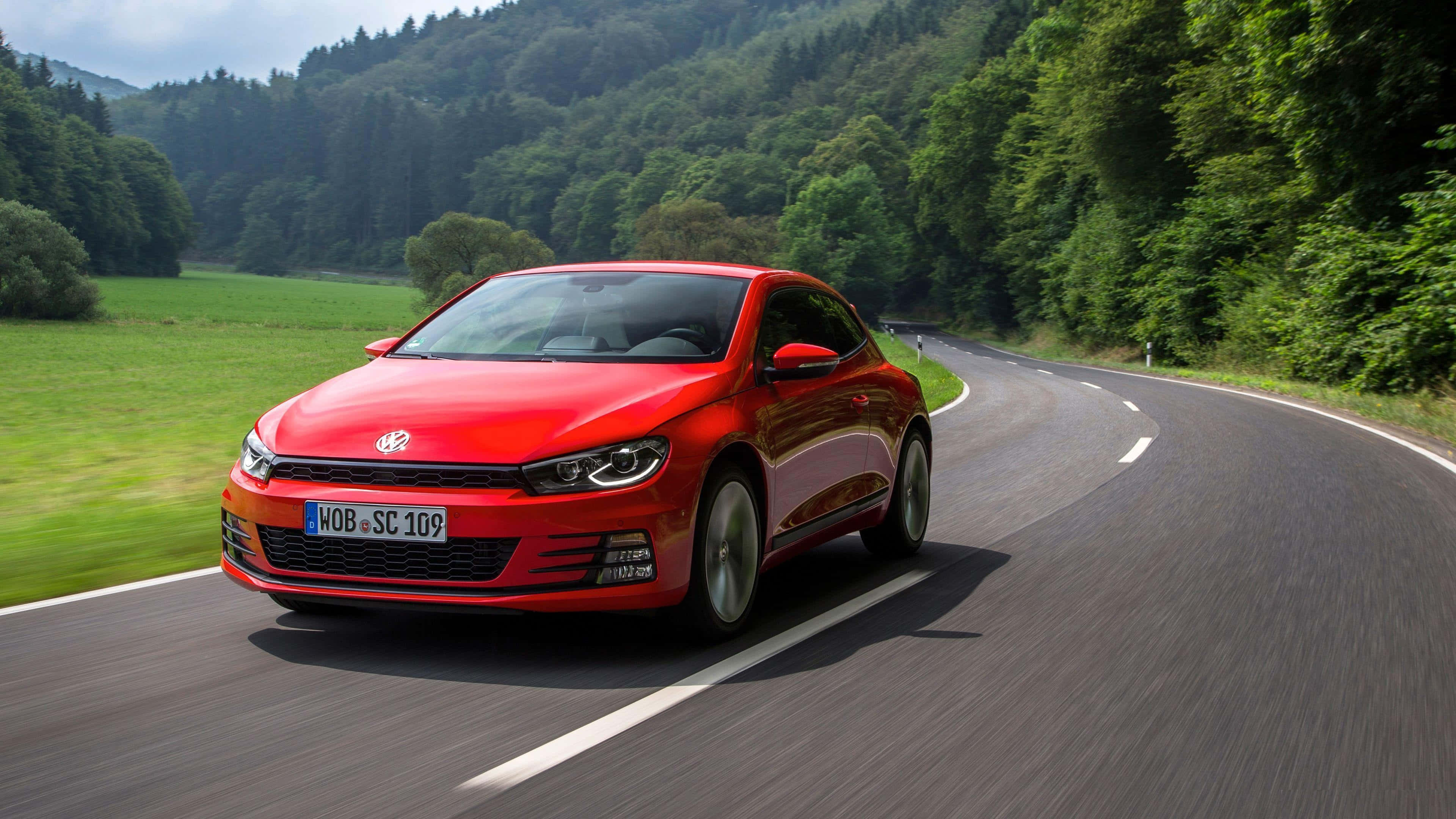 Volkswagen Scirocco, vibrant red, winding forest road, 4K Desktop Wallpaper