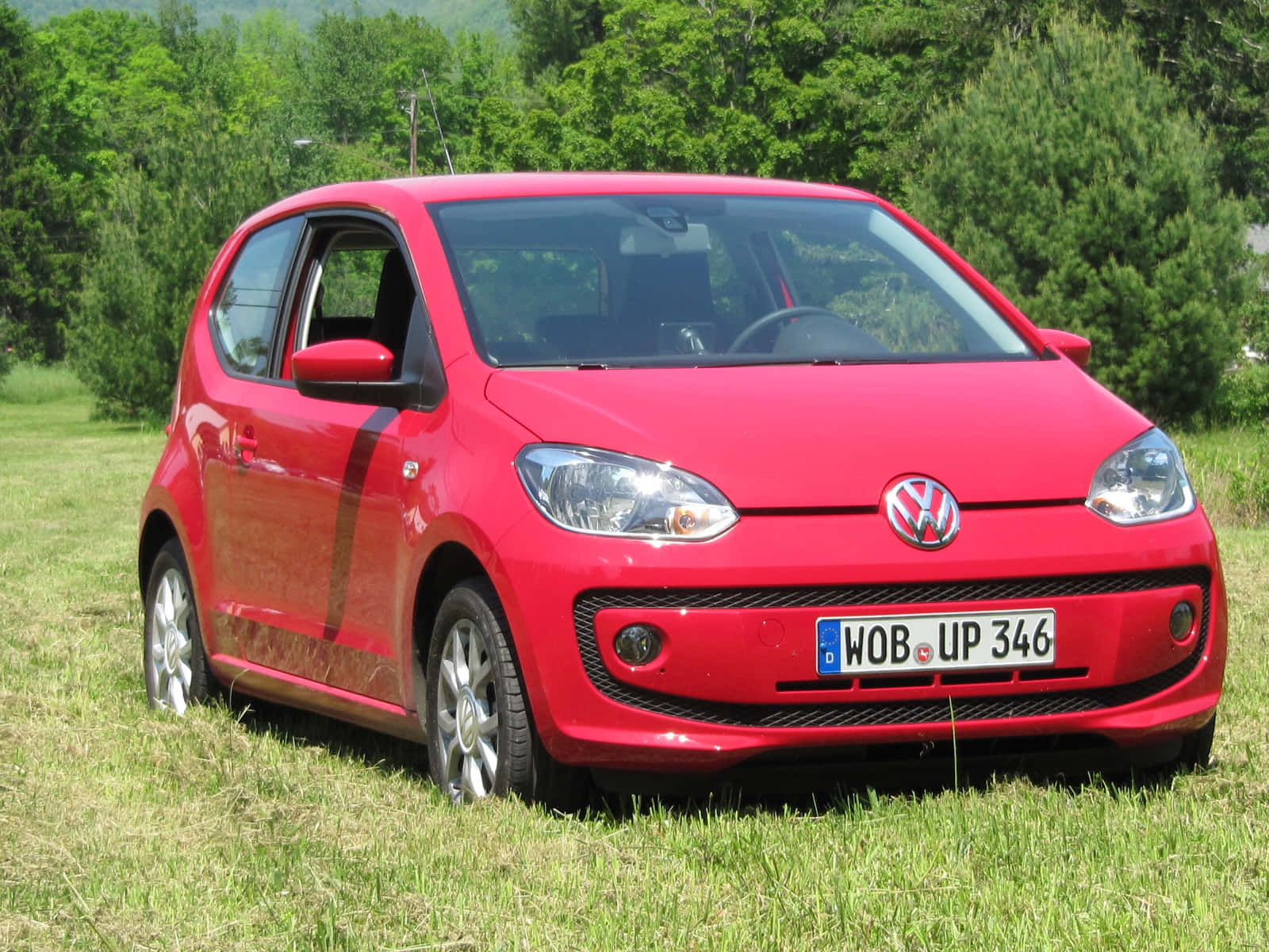 Red Volkswagen Up, grassy field, lush green trees, HD Desktop Wallpaper
