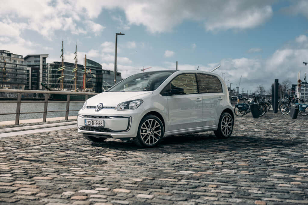 Volkswagen Up, white, cobblestone waterfront, SD Desktop Wallpaper