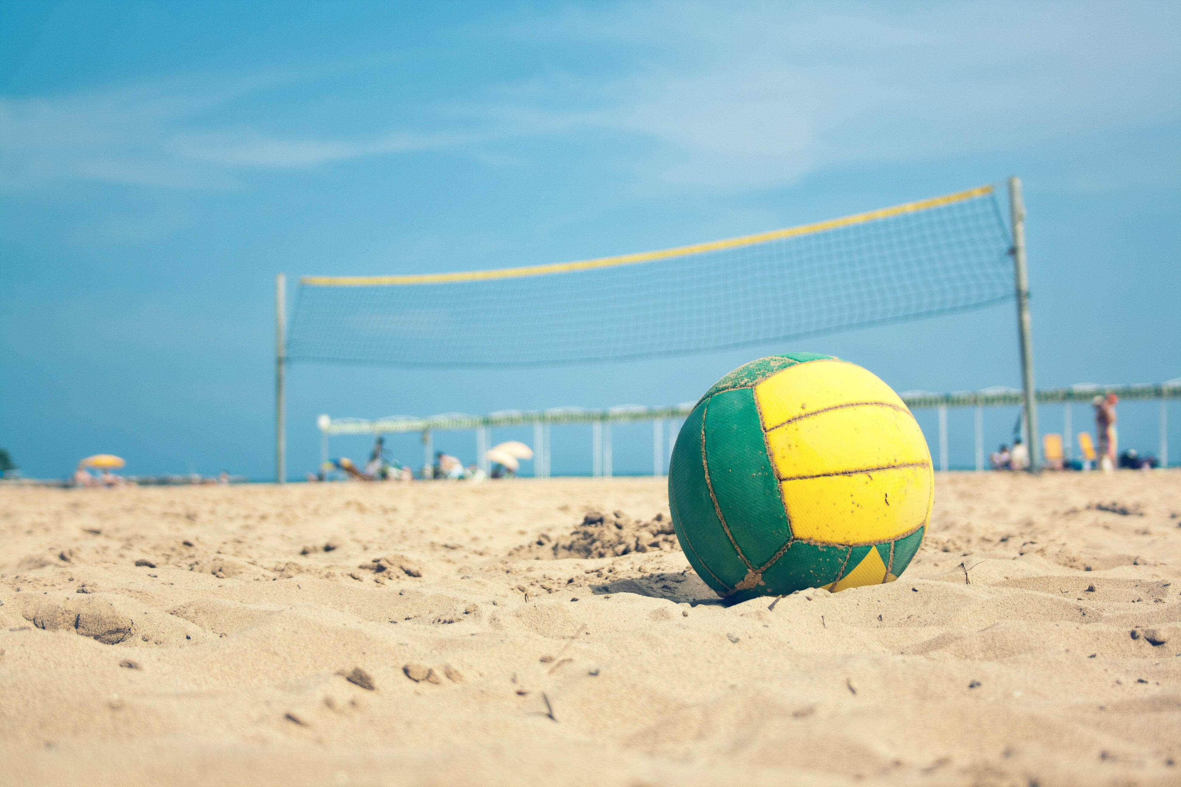 yellow and green volleyball, weathered green and yellow volleyball, warm sand, 4K Desktop Wallpaper