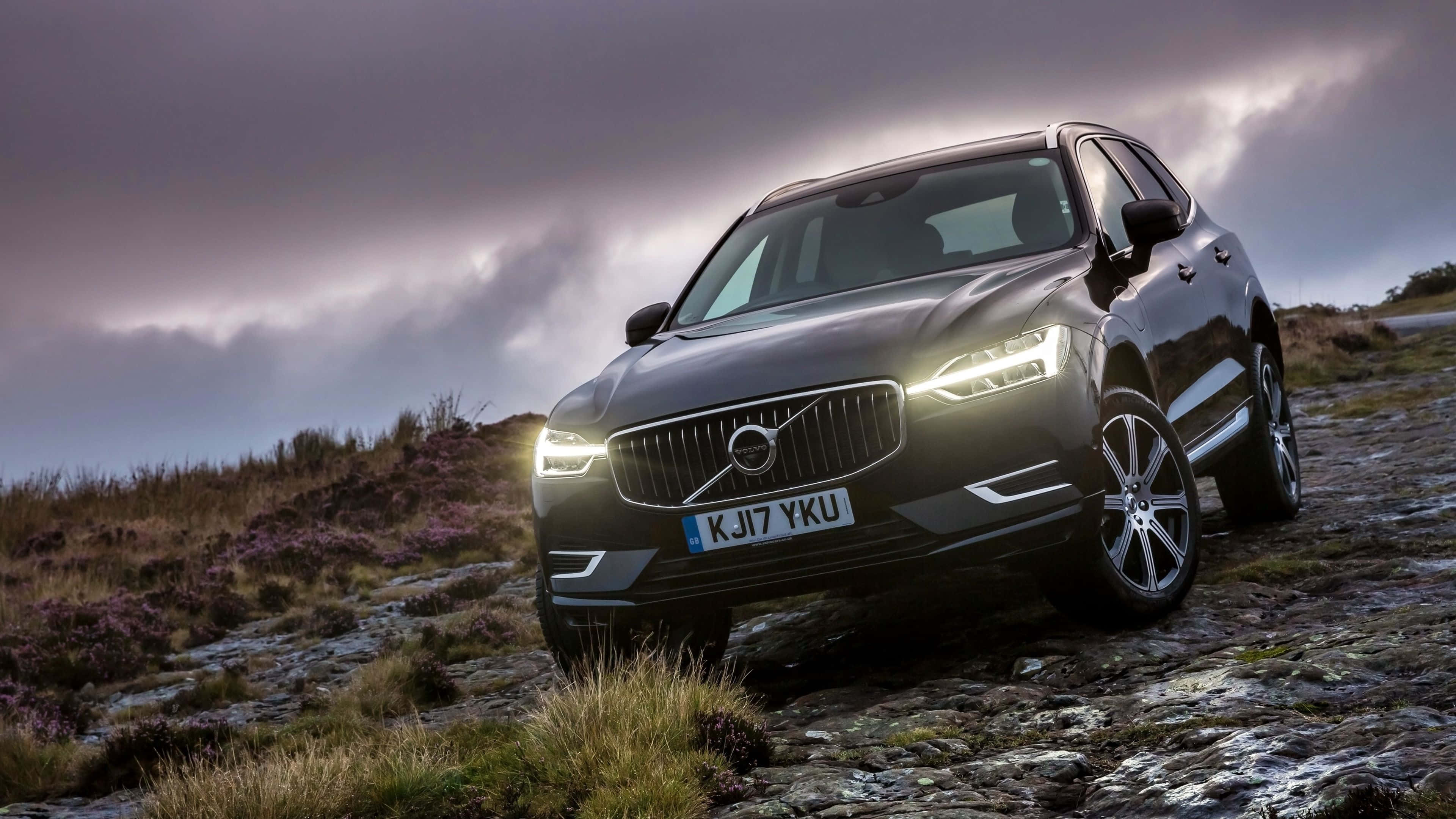 Volvo XC60, sleek black, glowing headlights, 4K Desktop Wallpaper