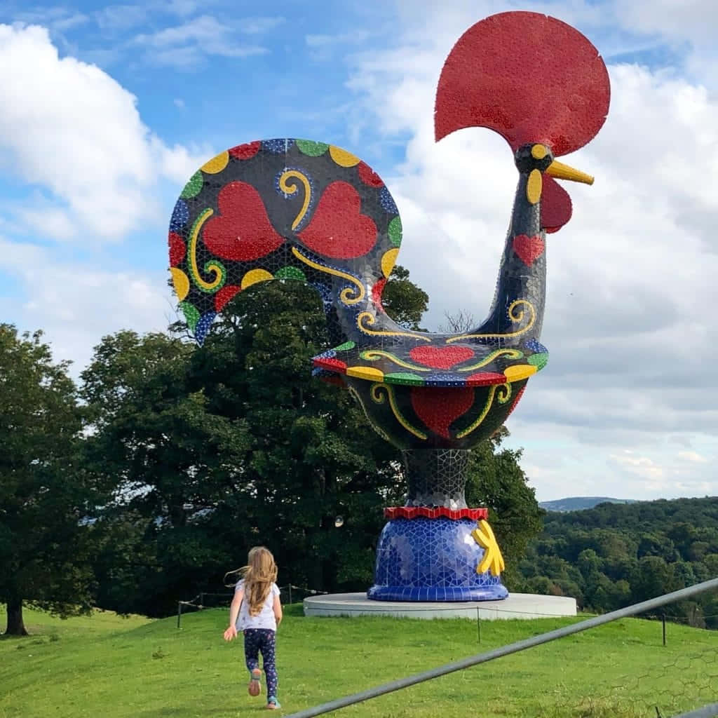 colorful mosaic rooster sculpture, child, partly cloudy sky, SD Desktop Wallpaper