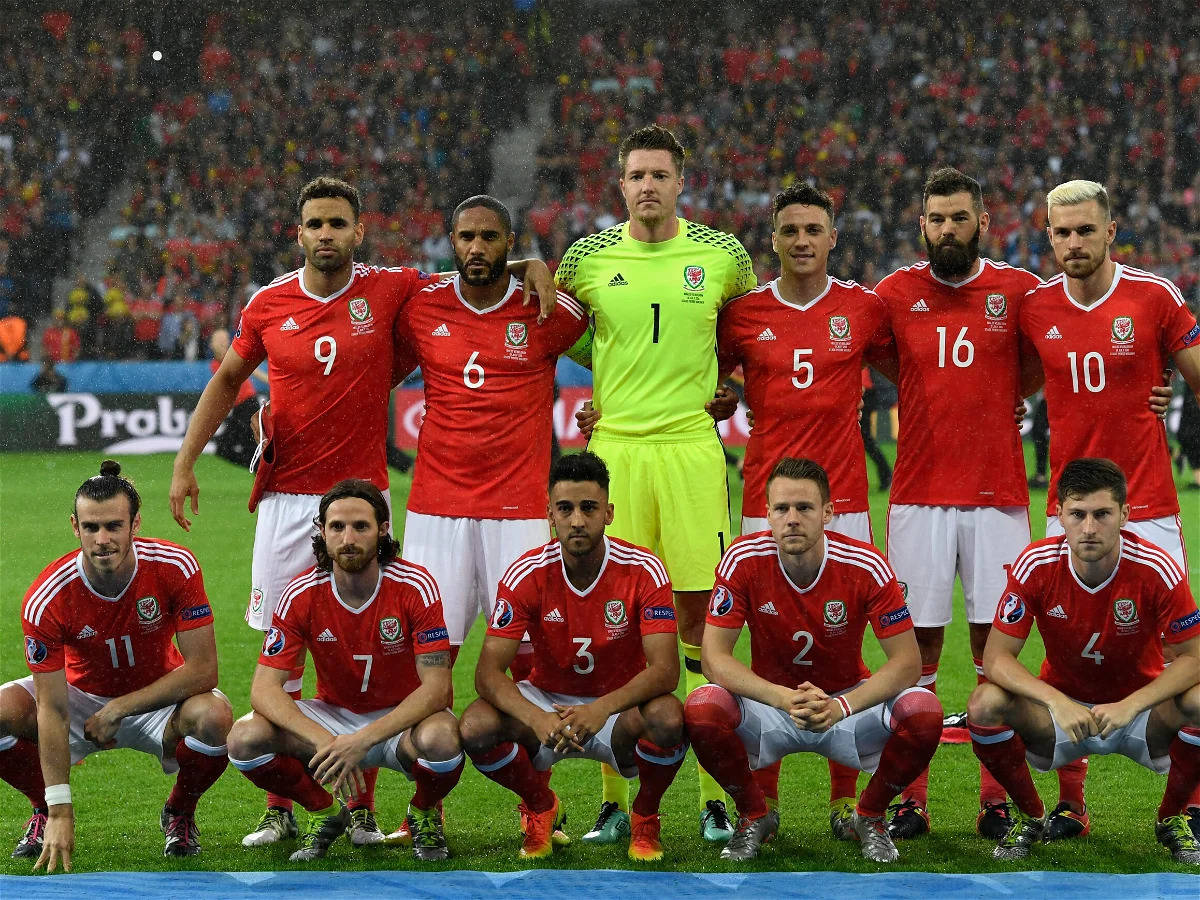 Wales National Football Team, red kits, rain-slicked pitch, SD Desktop Wallpaper