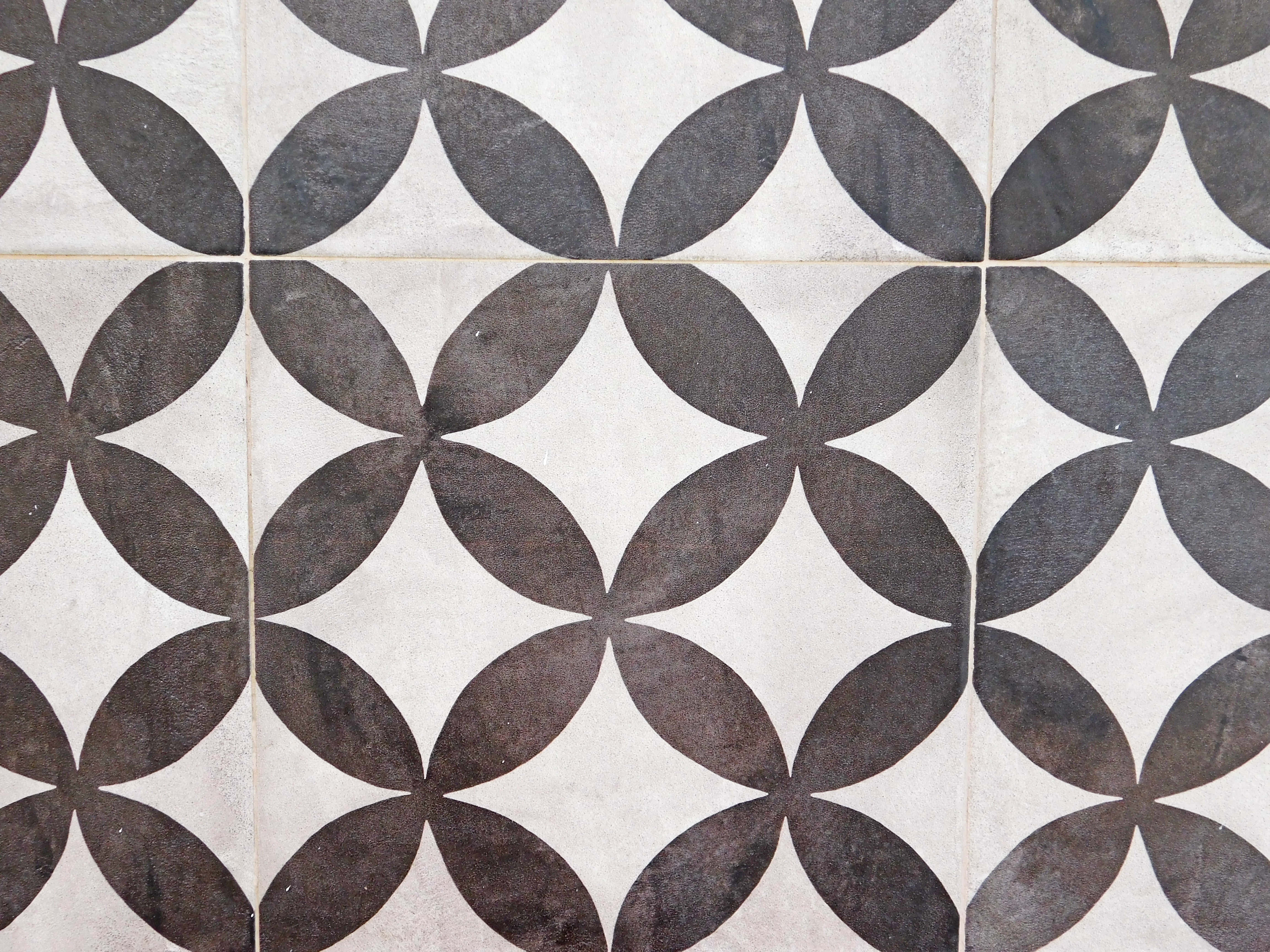 vintage black and white tiles, repeating quatrefoil patterns, visible grout lines, 4K Desktop Wallpaper