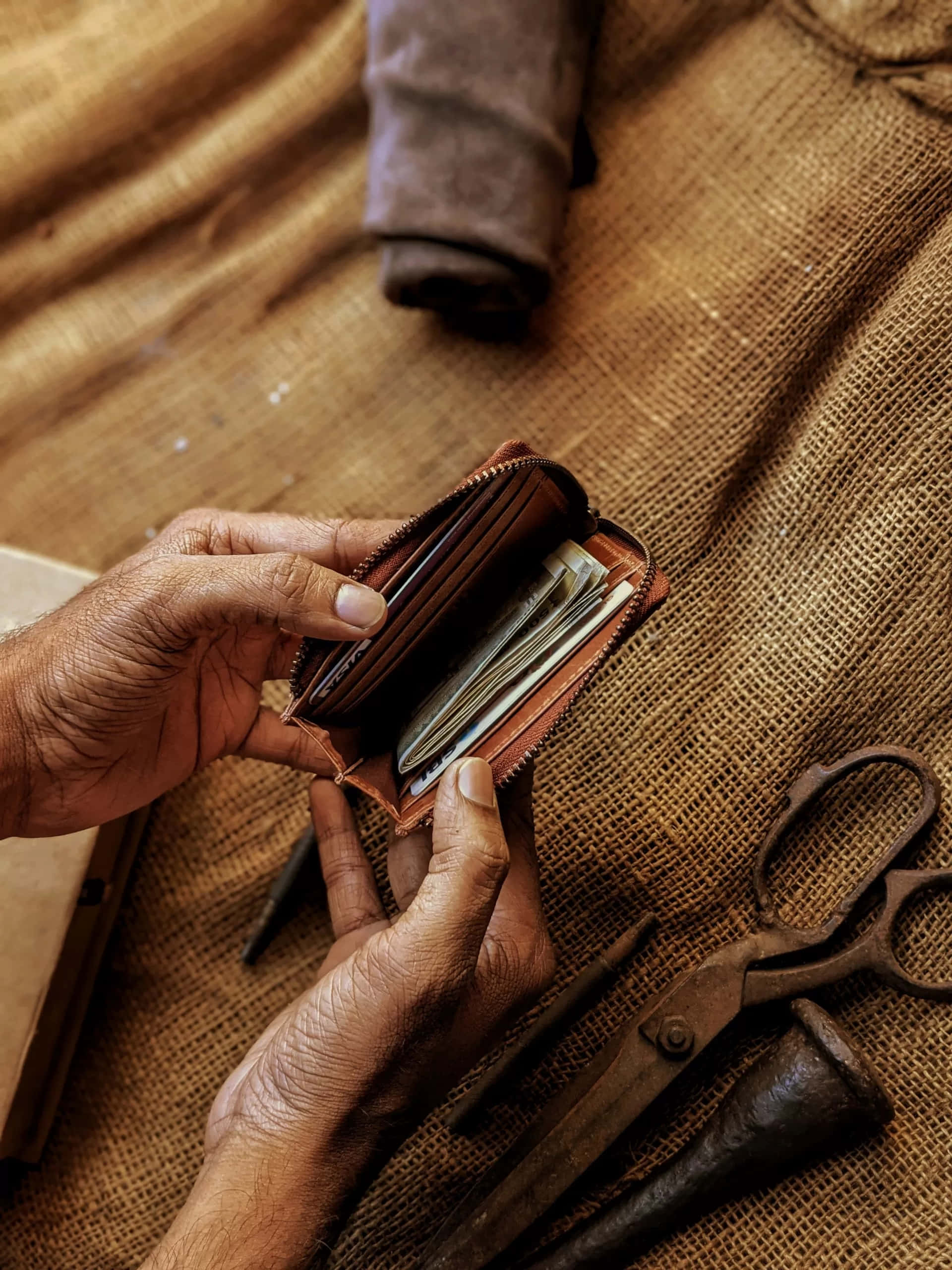 leather wallet, weathered hands, burlap surface, 2K Phone Wallpaper