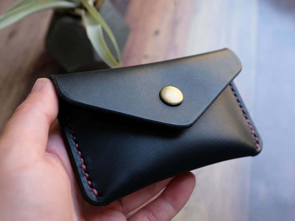 black leather wallet, button closure, red stitching, SD Desktop Wallpaper