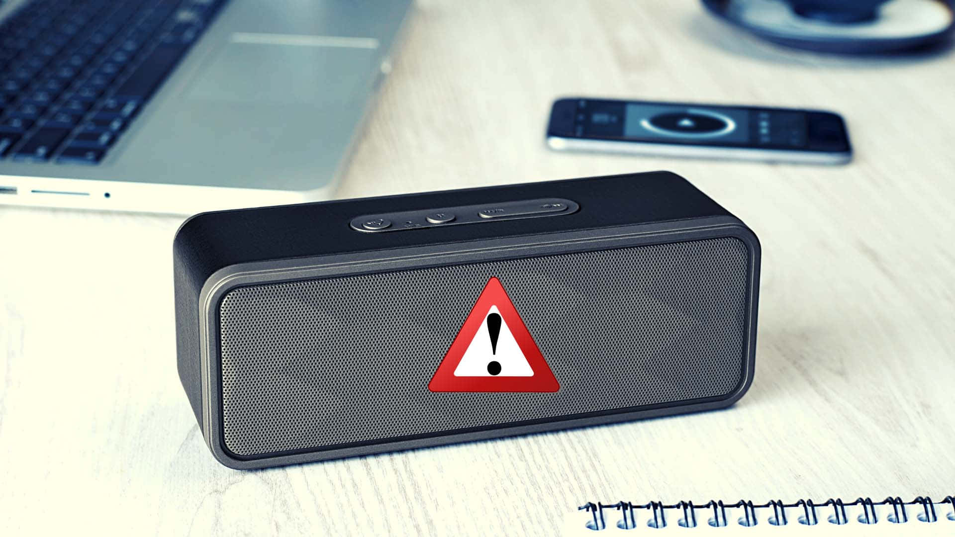 black portable speaker, red warning triangle sticker, wooden desk, Full HD Desktop Wallpaper