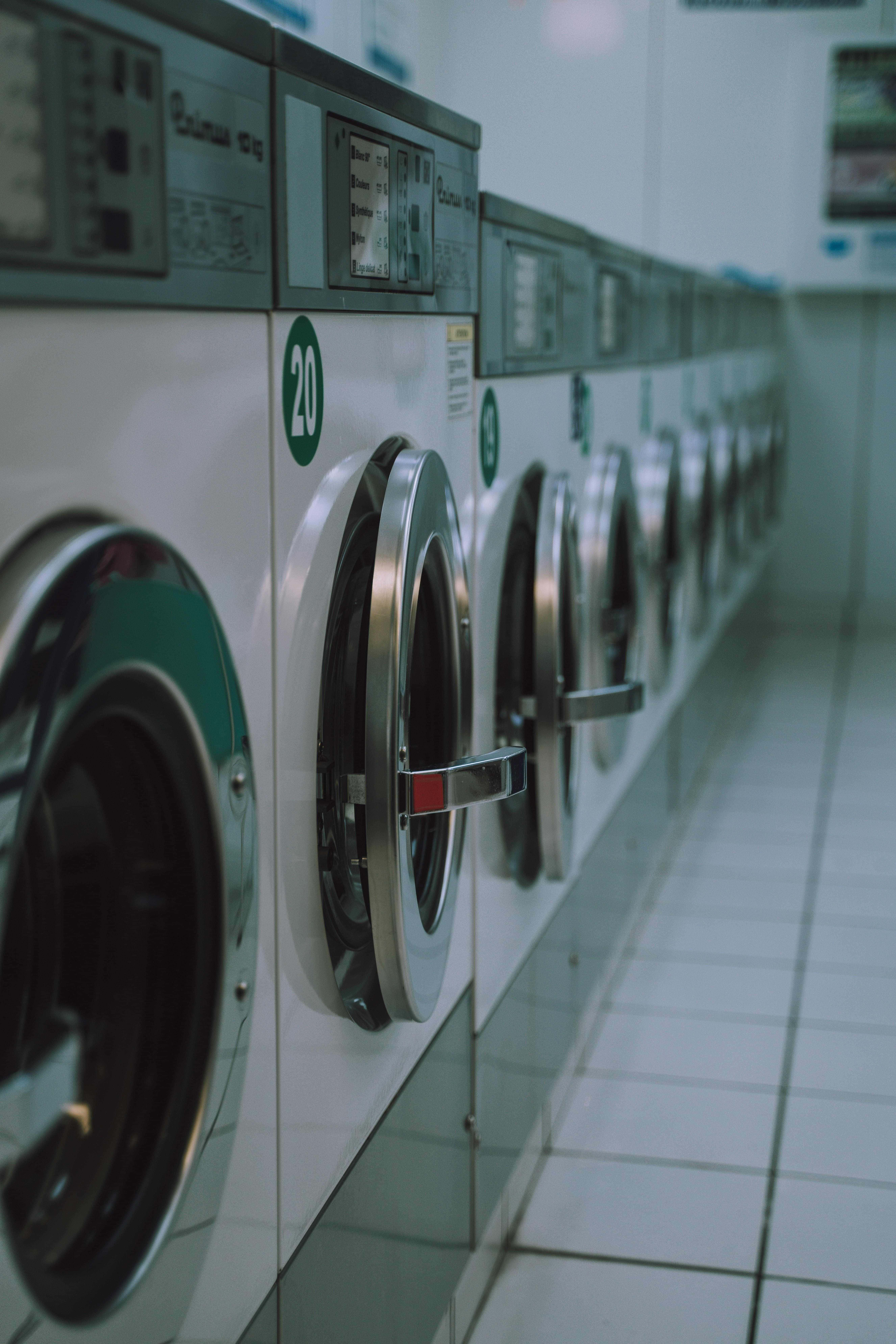 white industrial washing machines, chrome doors, tiled laundry room hallway, 8K Phone Wallpaper