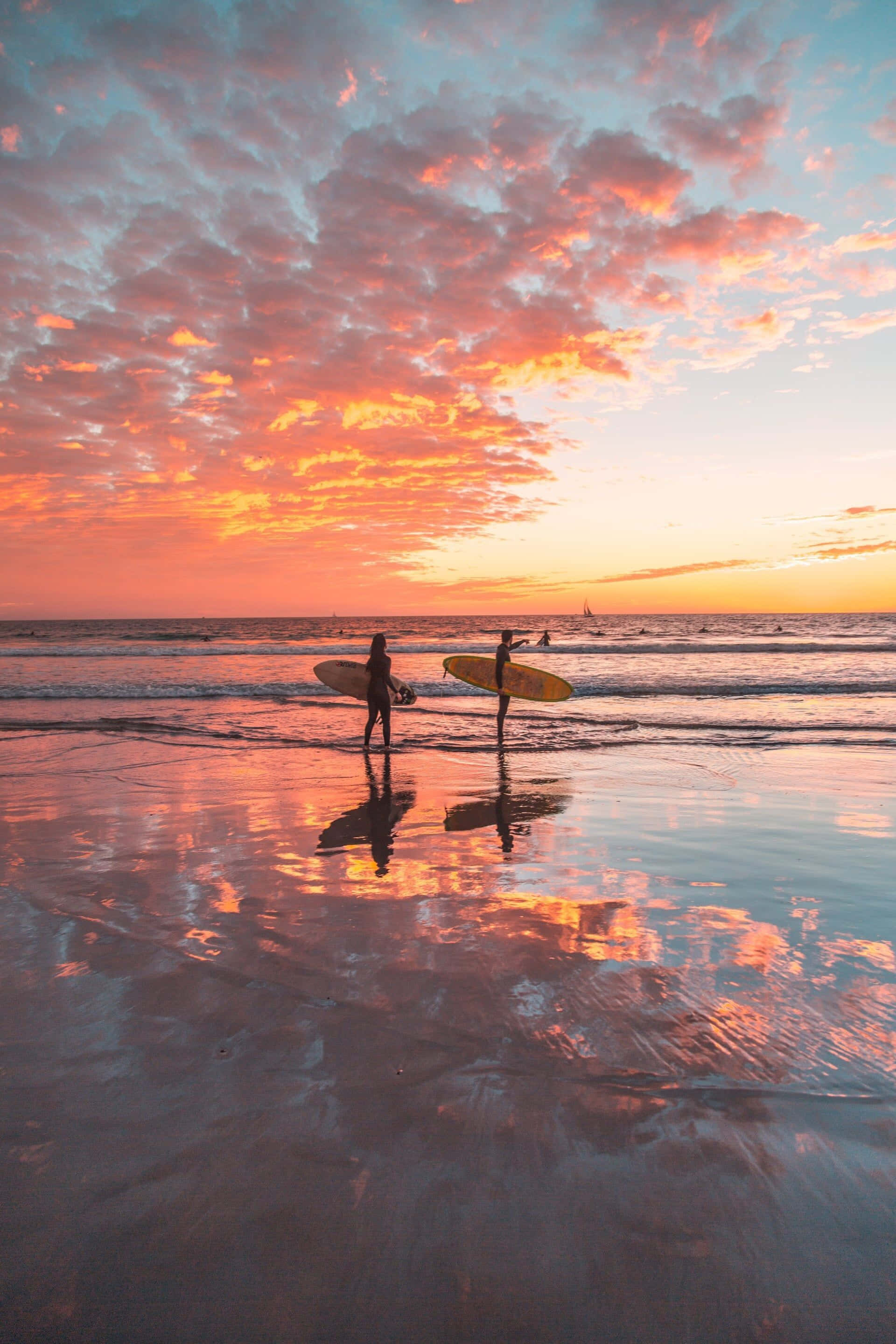 beach water sports, sunset, vibrant orange and pink clouds, 2K Phone Wallpaper