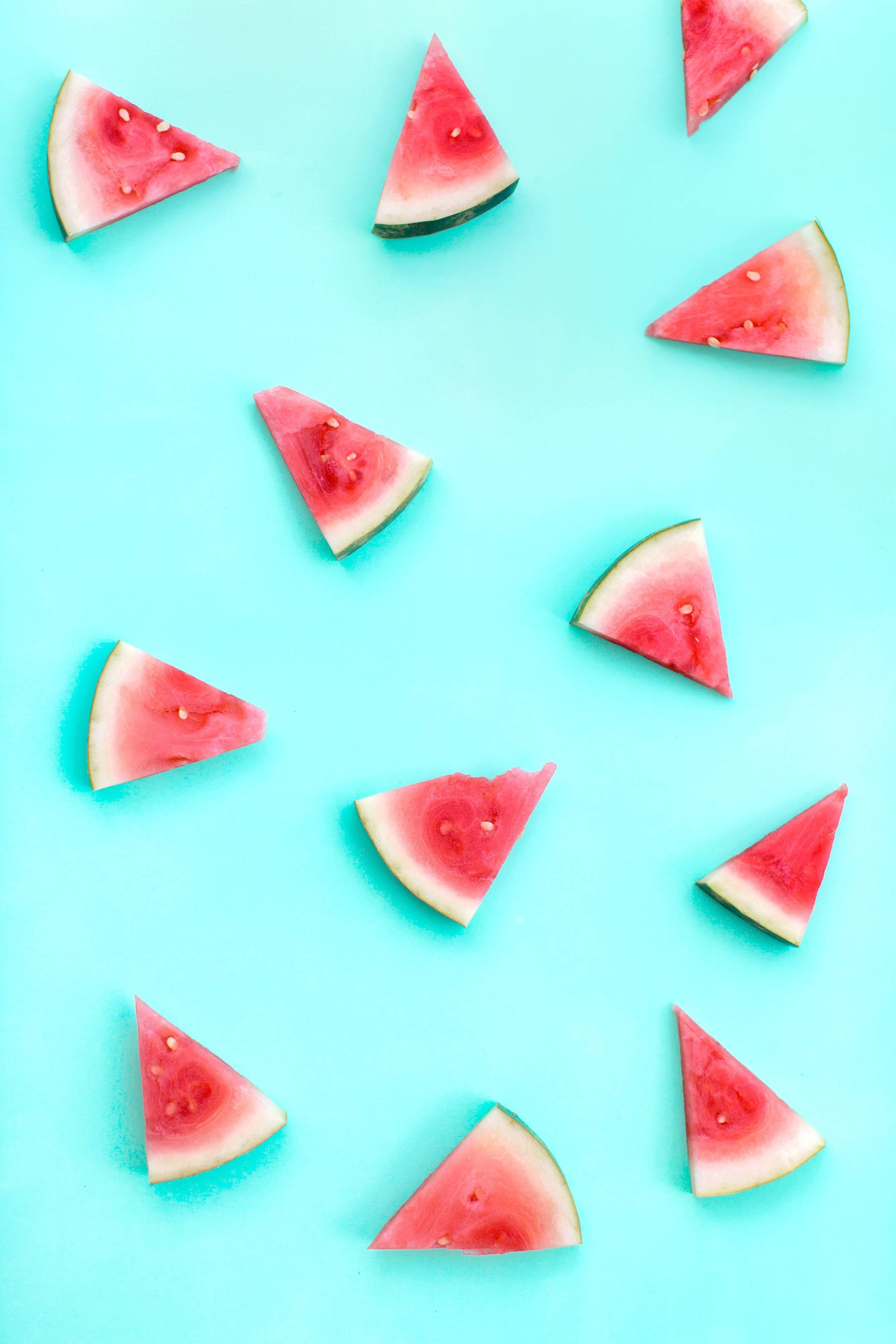 Watermelon Slices Pattern, vibrant turquoise background, flat lay composition, 2K Phone Wallpaper