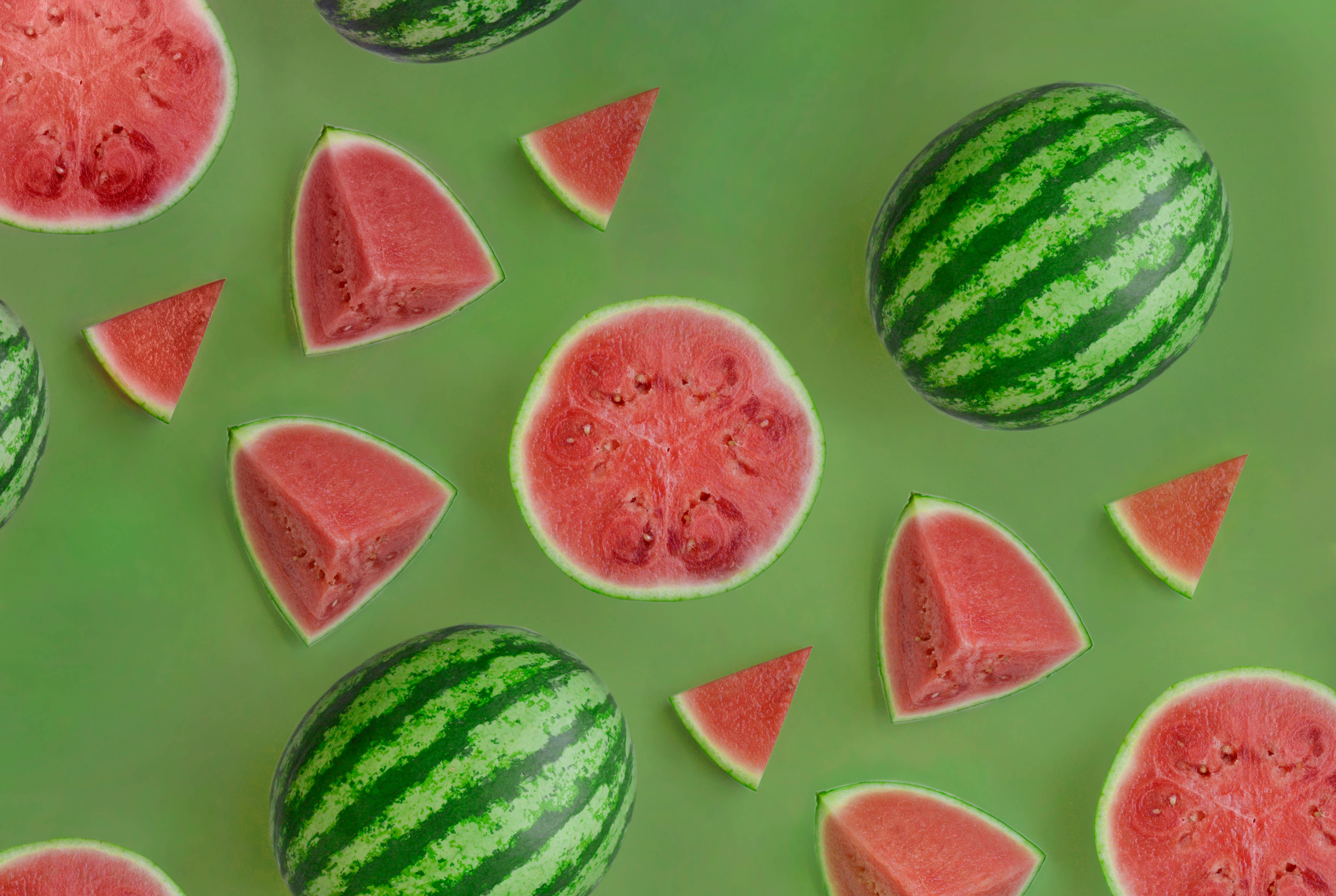watermelon, vibrant green background, flat lay composition, 4K Desktop Wallpaper