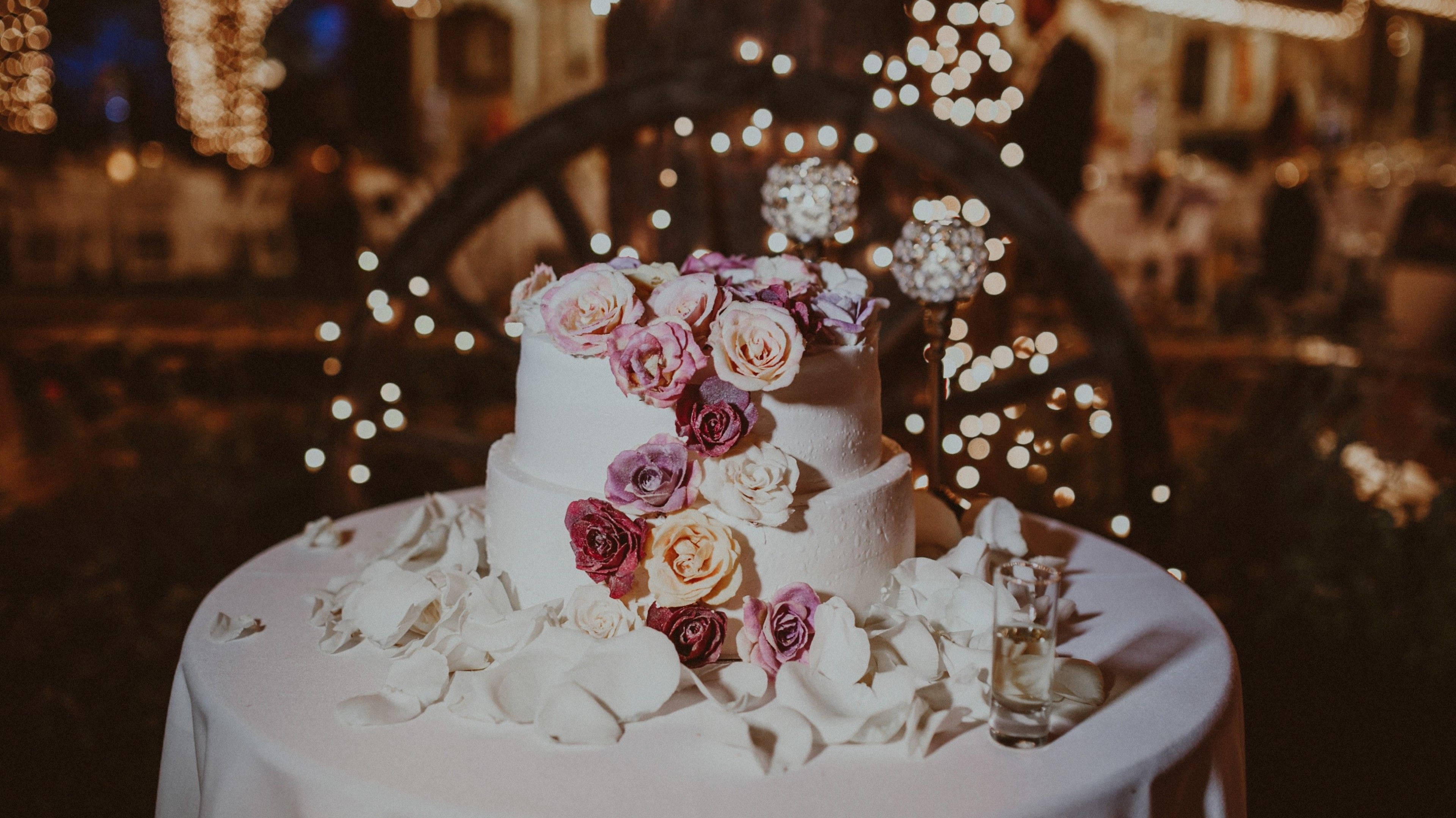 white wedding cake, two-tiered, cascading pink and purple roses, 4K Desktop Wallpaper