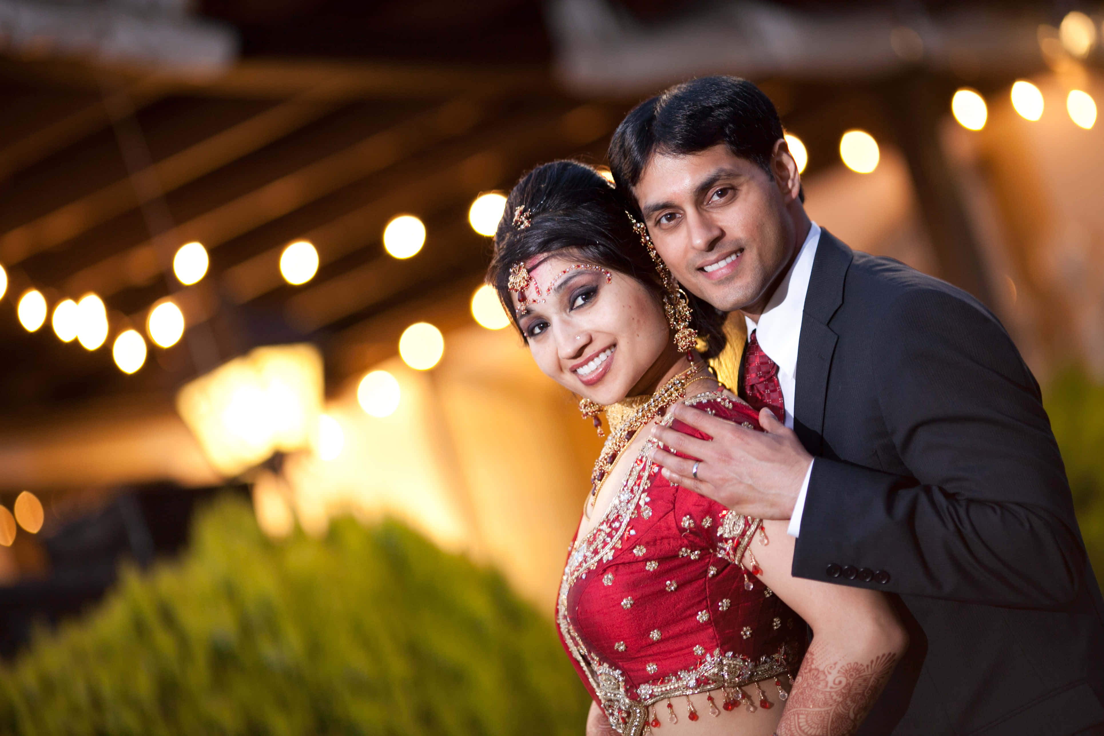 Indian Wedding Couple, glowing string lights, evening outdoor celebration, 4K Desktop Wallpaper