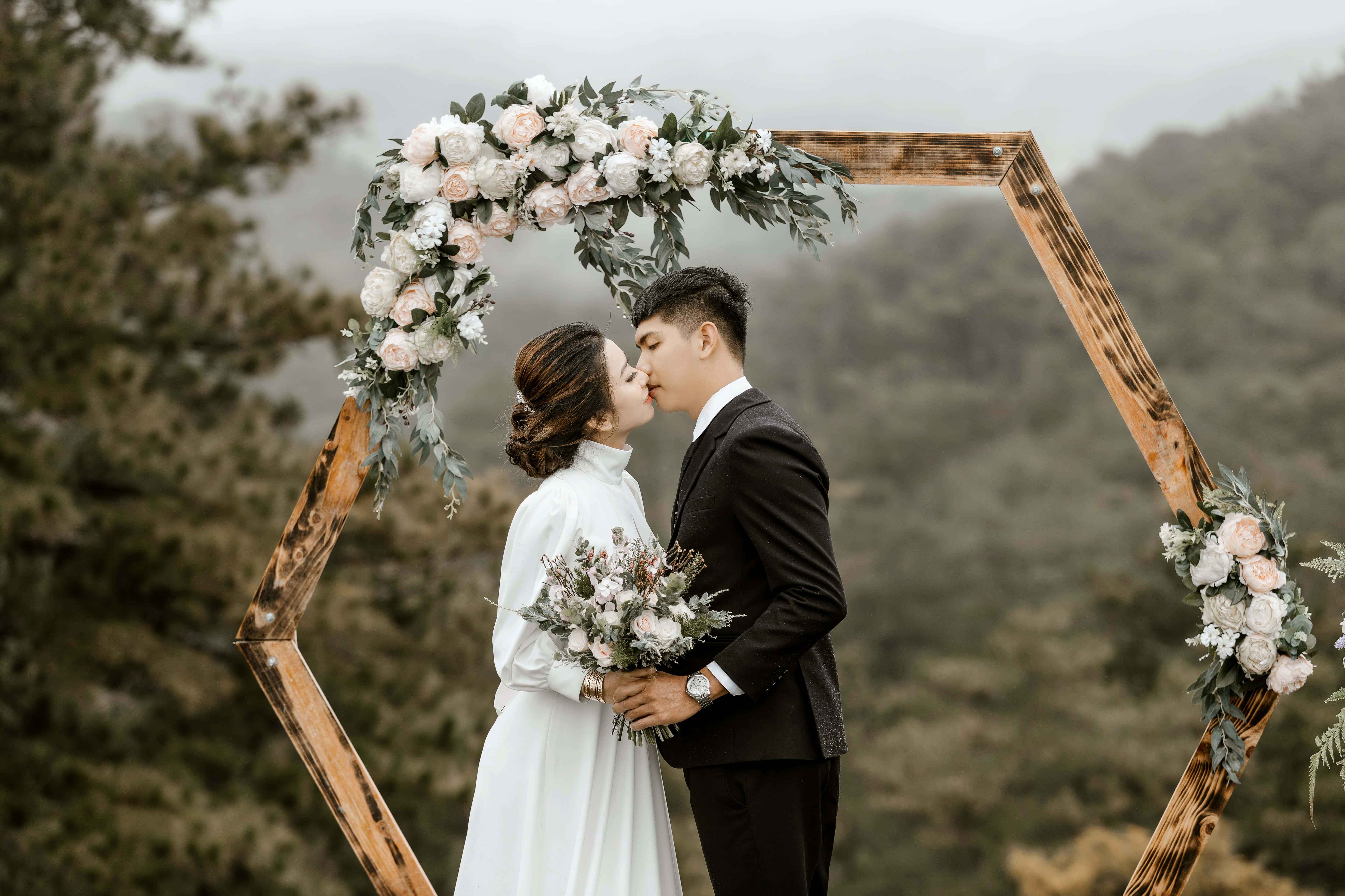 rustic wooden arch, soft pink and white flowers, misty forest backdrop, 5K Desktop Wallpaper