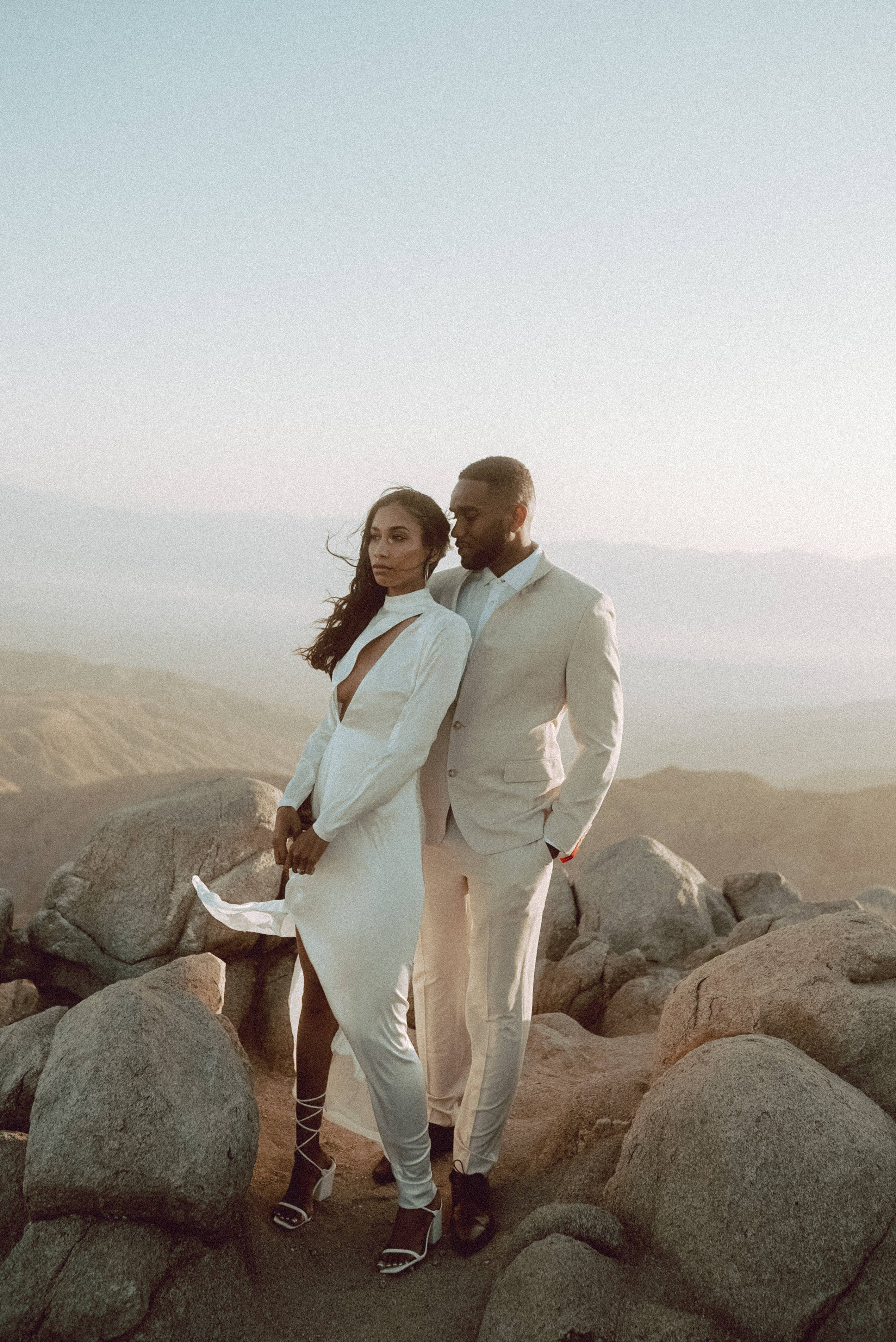 couple, white outfits, rocky mountain terrain, 4K Phone Wallpaper