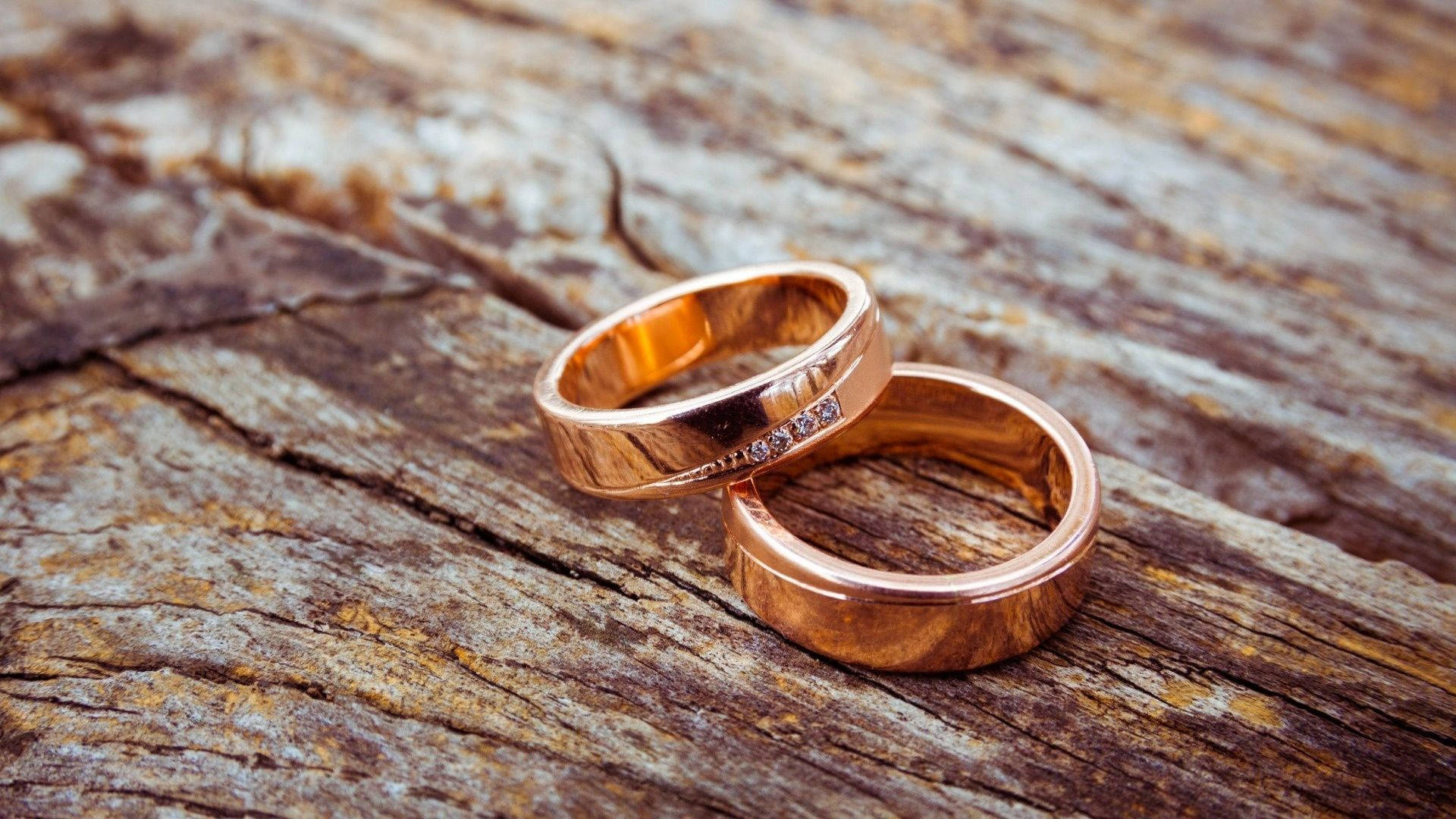 rose gold wedding bands, diamond accents, weathered wooden surface, Full HD Desktop Wallpaper
