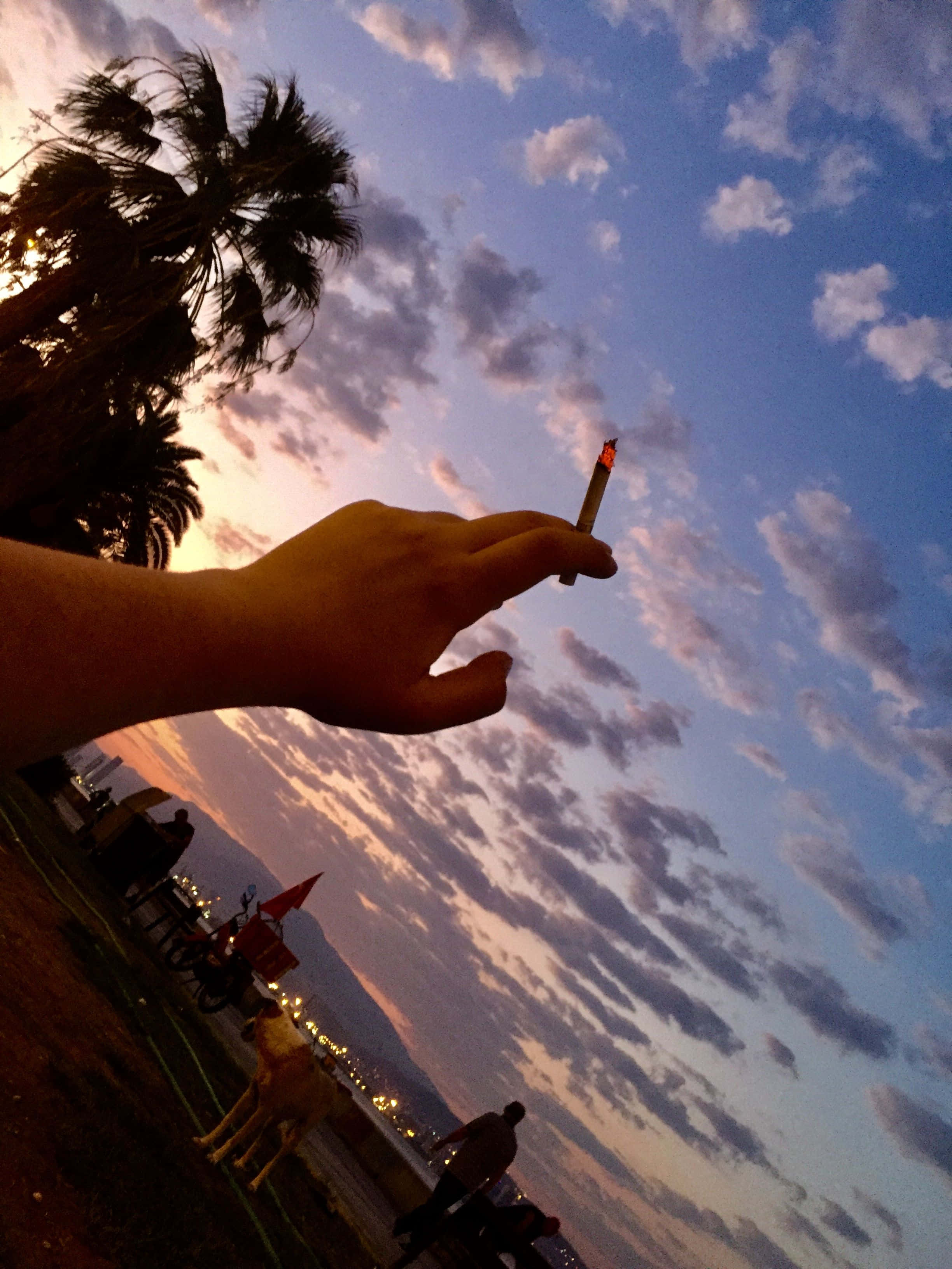 weed blunt, lit cigarette, vibrant twilight sky, 2K Phone Wallpaper