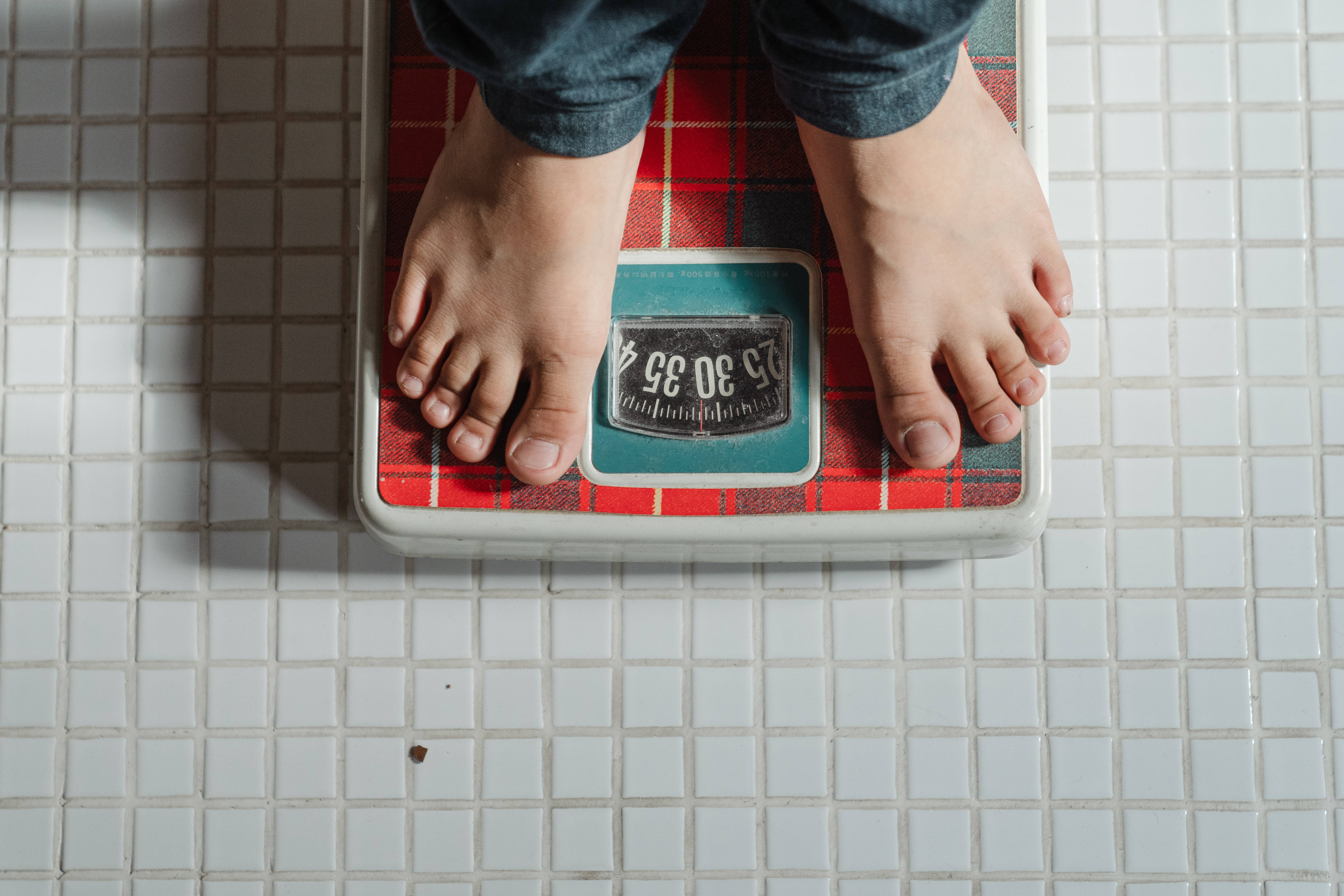 vintage red plaid bathroom scale, white tiled flooring, bare feet, 5K Desktop Wallpaper