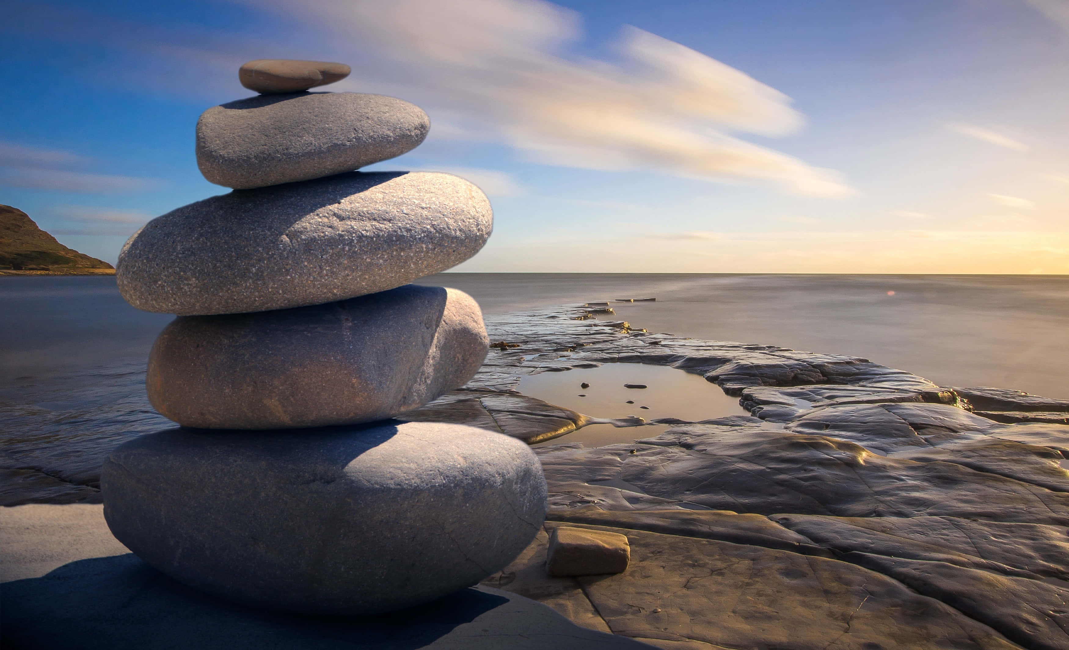 serenity and calm at sunrise, golden hour, rocky shoreline, 2K Desktop Wallpaper