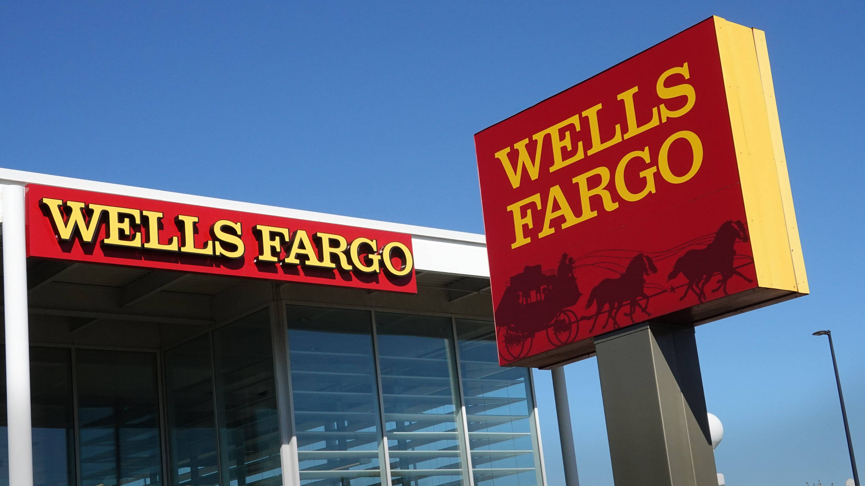 Wells Fargo, red and yellow signage, horse-drawn carriage logo, 2K Desktop Wallpaper