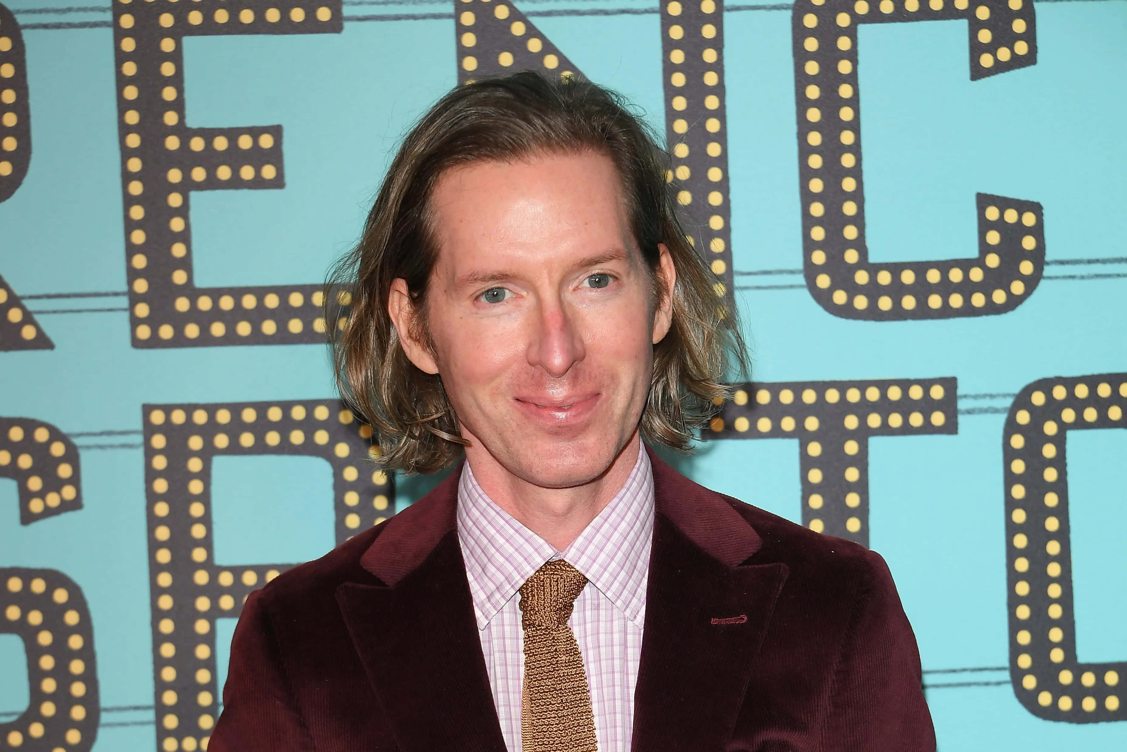 Wes Anderson style, maroon velvet blazer, light blue backdrop, 2K Desktop Wallpaper