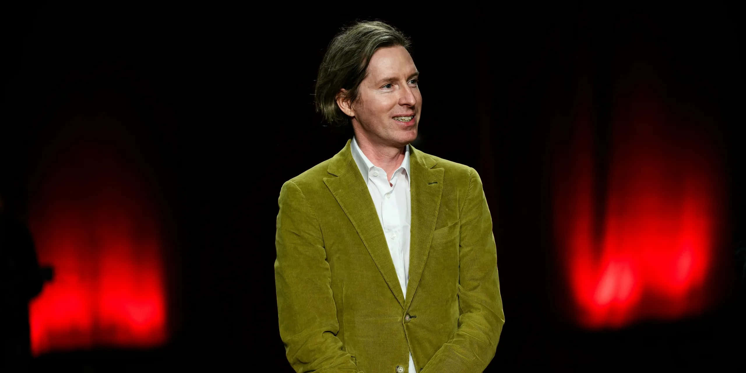 Wes Anderson, green corduroy blazer, dark backdrop, 2K Desktop Wallpaper