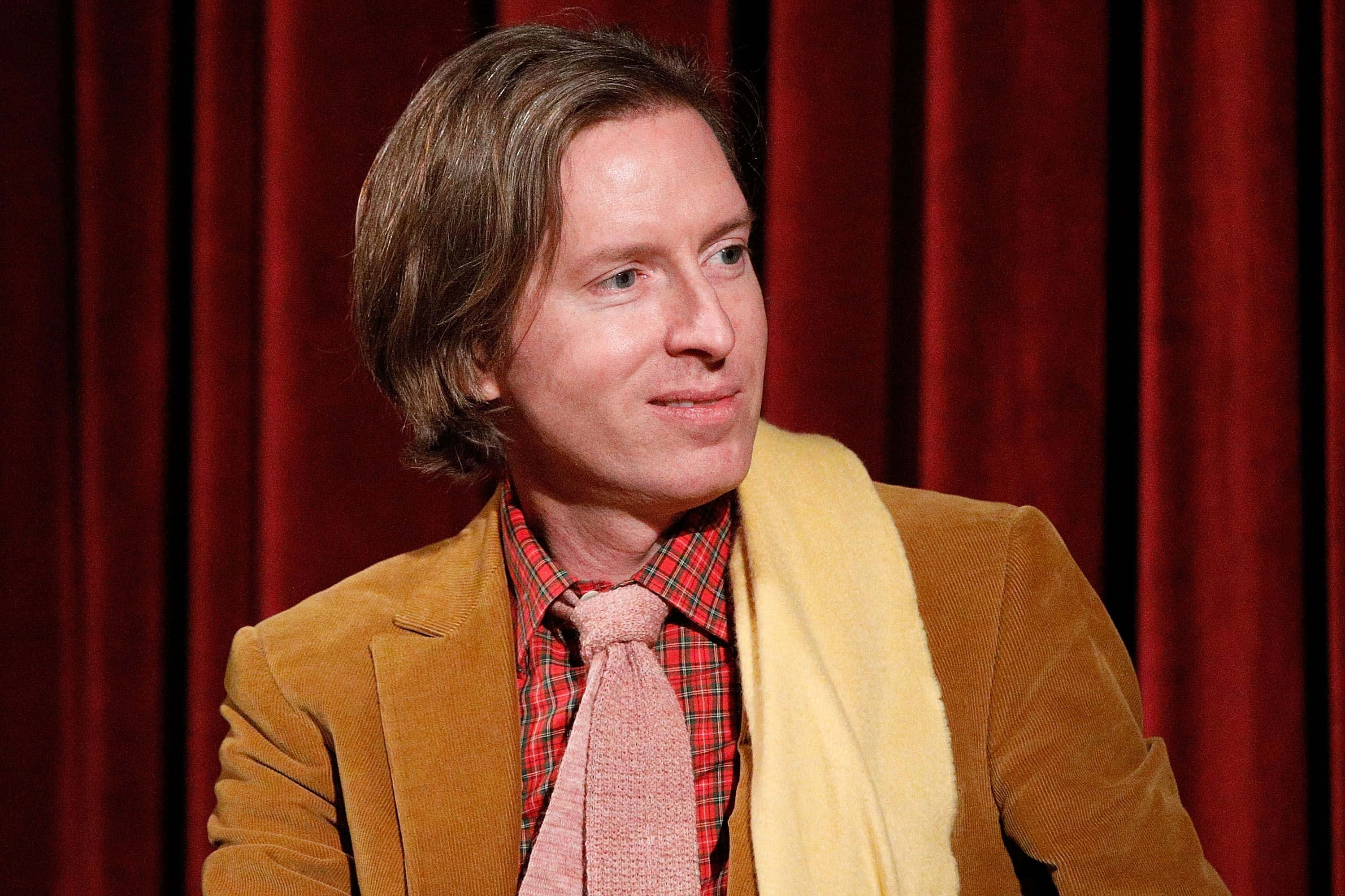 Wes Anderson, mustard jacket, pink tie, 2K Desktop Wallpaper