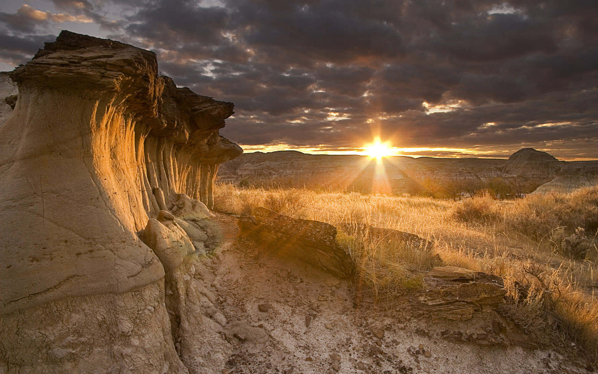 Sunset, rock formations, dry grasses, Full HD Desktop Wallpaper