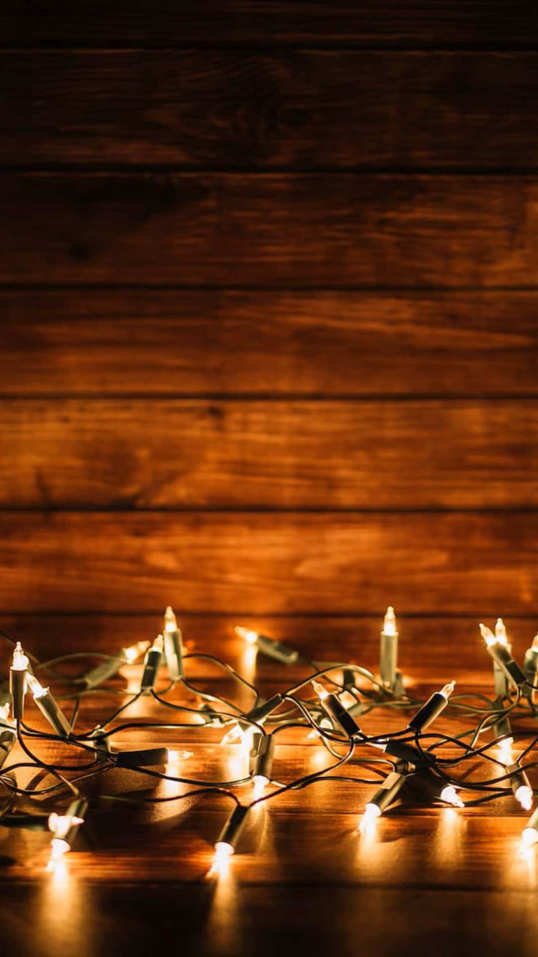 warm white christmas lights, rustic wooden surface, soft golden reflections, Full HD Phone Wallpaper