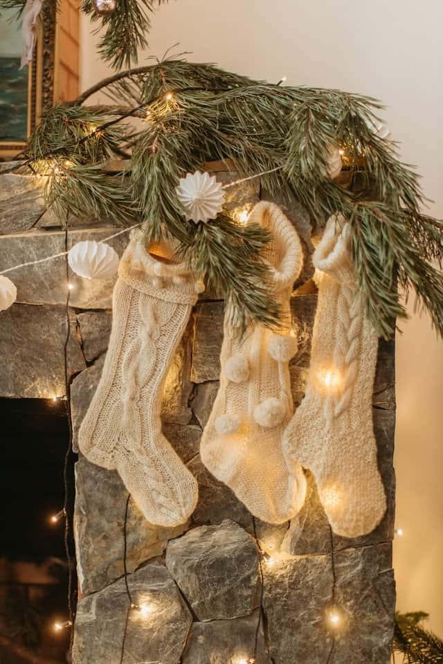cream knit stockings, pom poms, pine garland, SD Phone Wallpaper