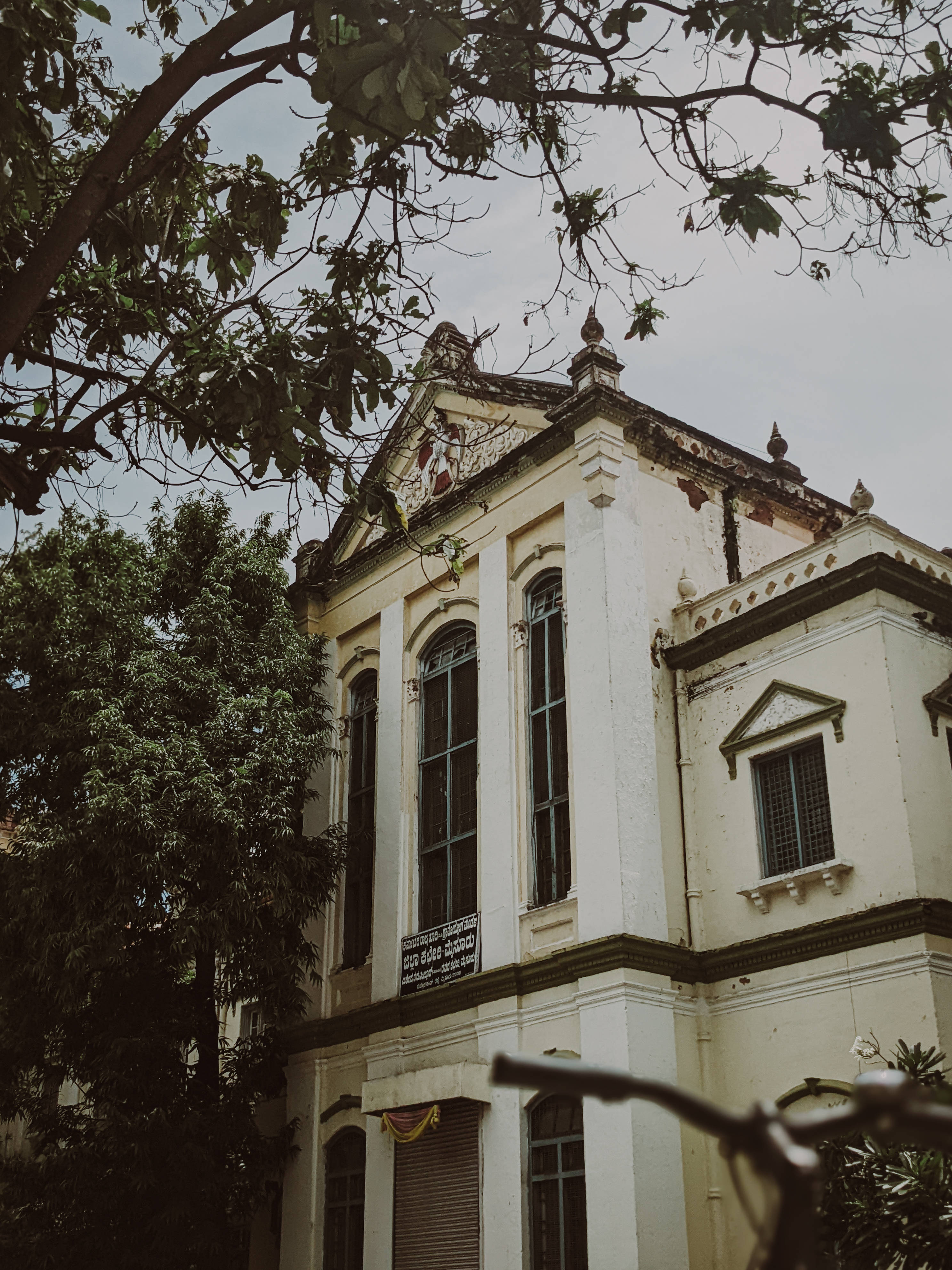 colonial-style building, peeling white paint, arched windows, 4K Phone Wallpaper