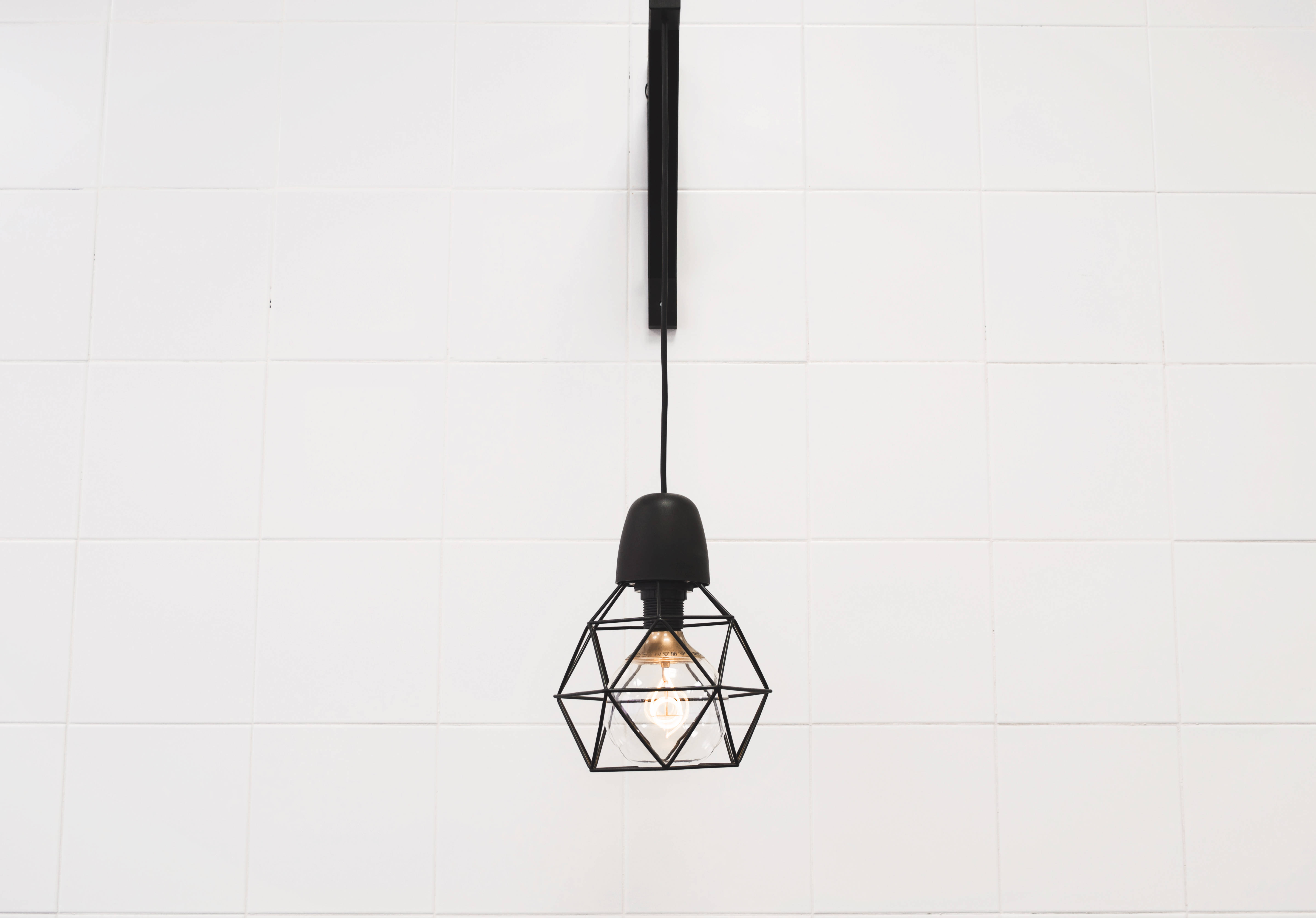 black geometric cage pendant light, white tiled wall, minimalist backdrop, 5K Desktop Wallpaper