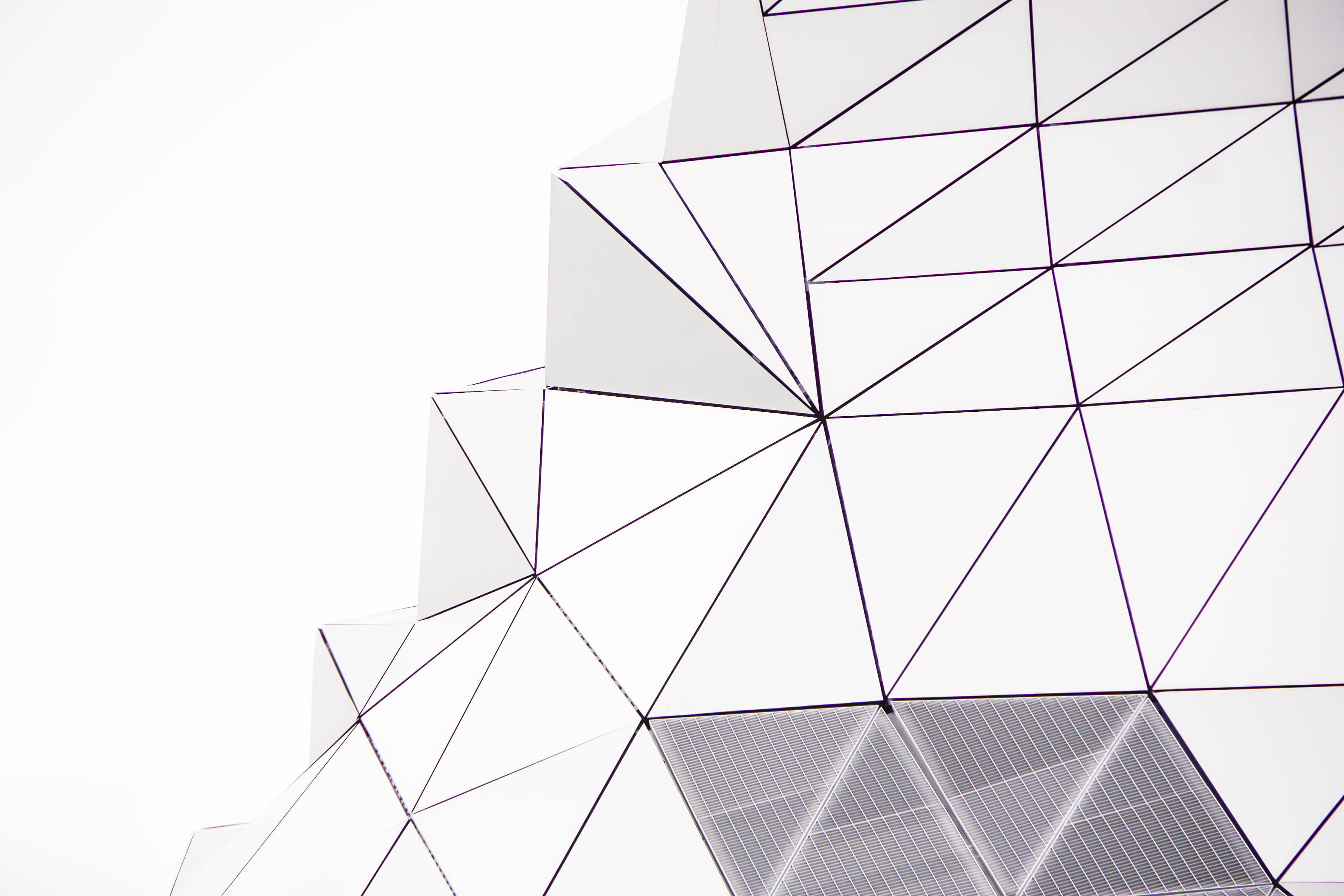 white minimalist, geometric building, sharp triangular panels, 2K Desktop Wallpaper
