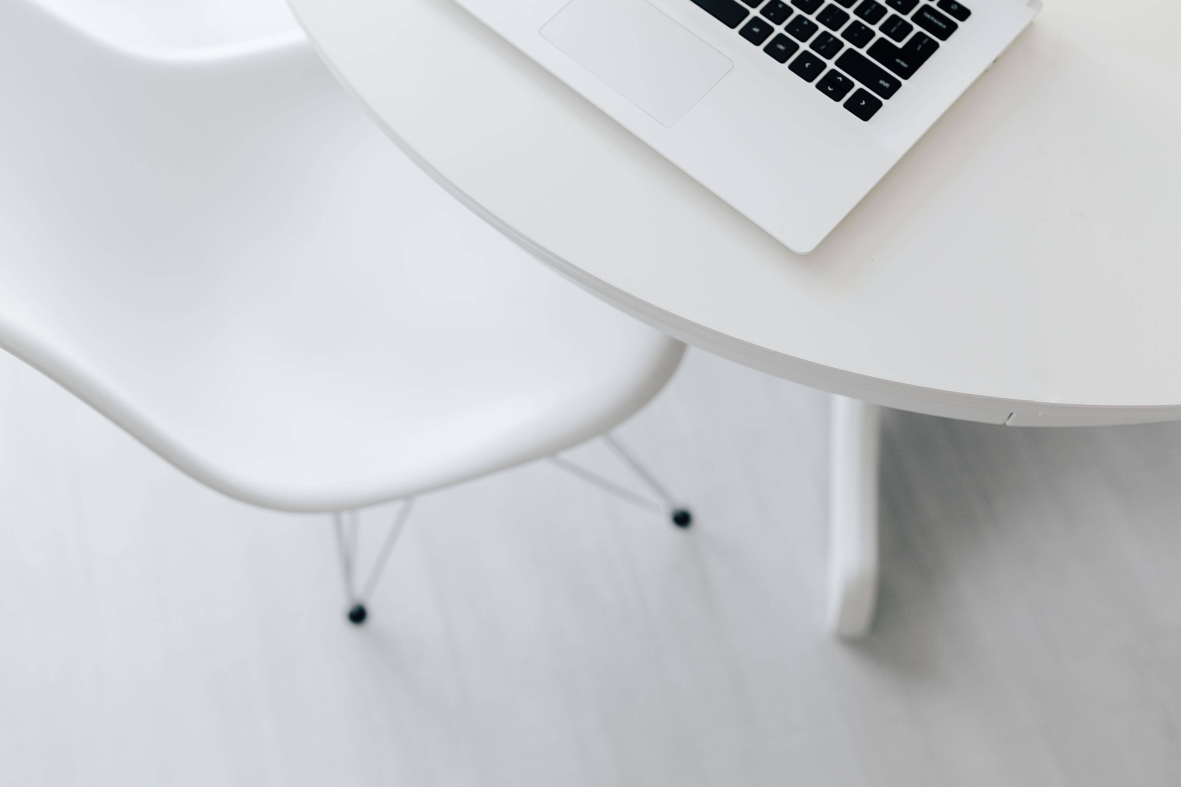 white minimalist workstation, minimalist white laptop, sleek white round table, 2K Desktop Wallpaper