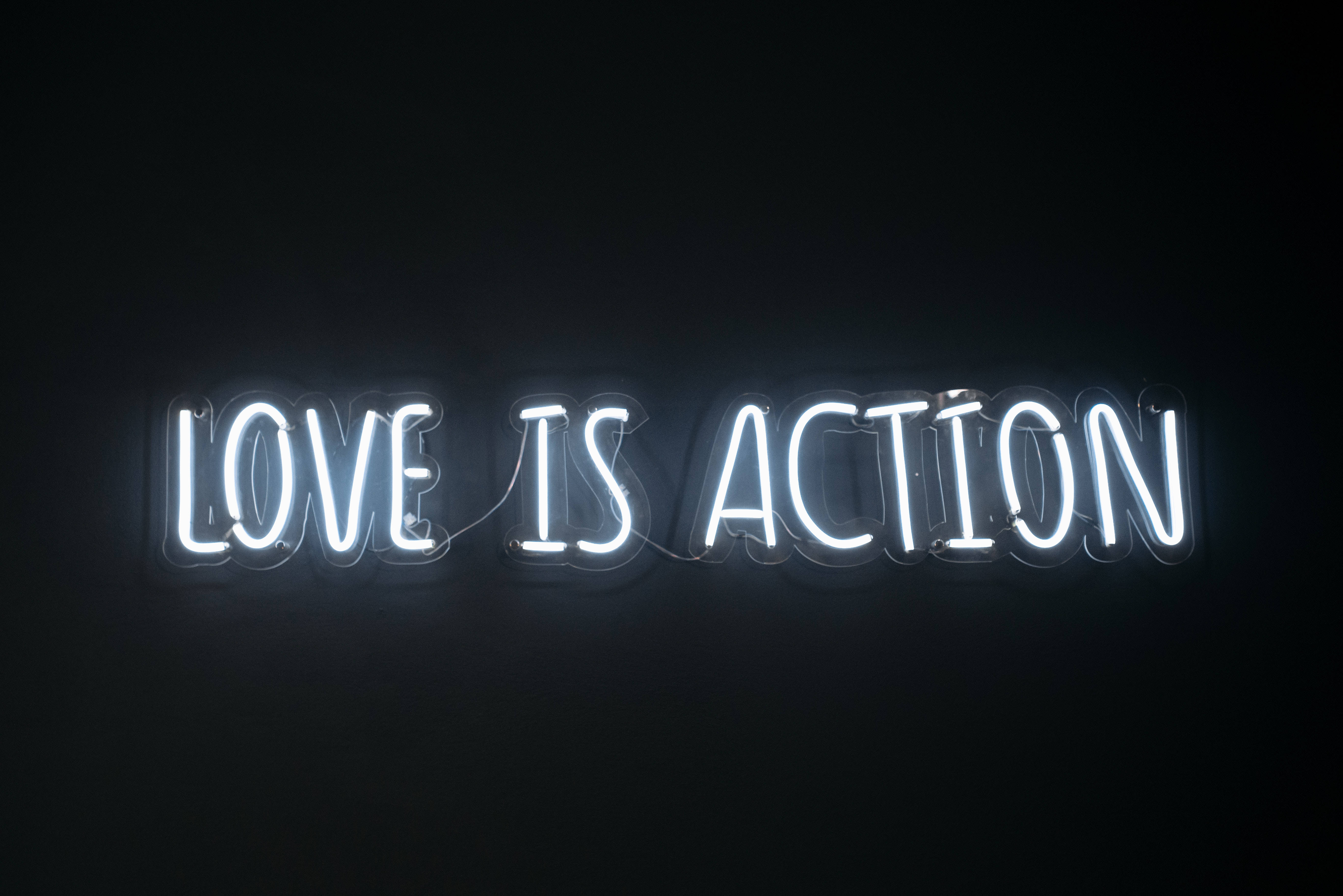 LOVE IS ACTION, white neon sign, stark black background, 5K Desktop Wallpaper