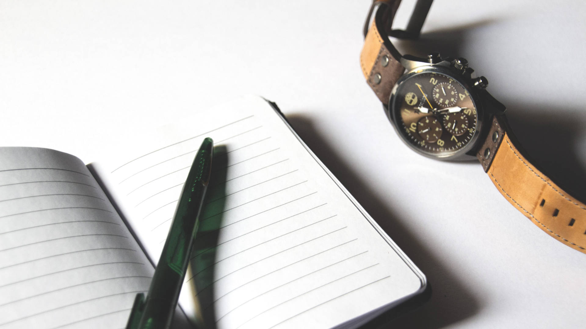pristine white wall, sleek chronograph watch, tan leather strap, Full HD Desktop Wallpaper