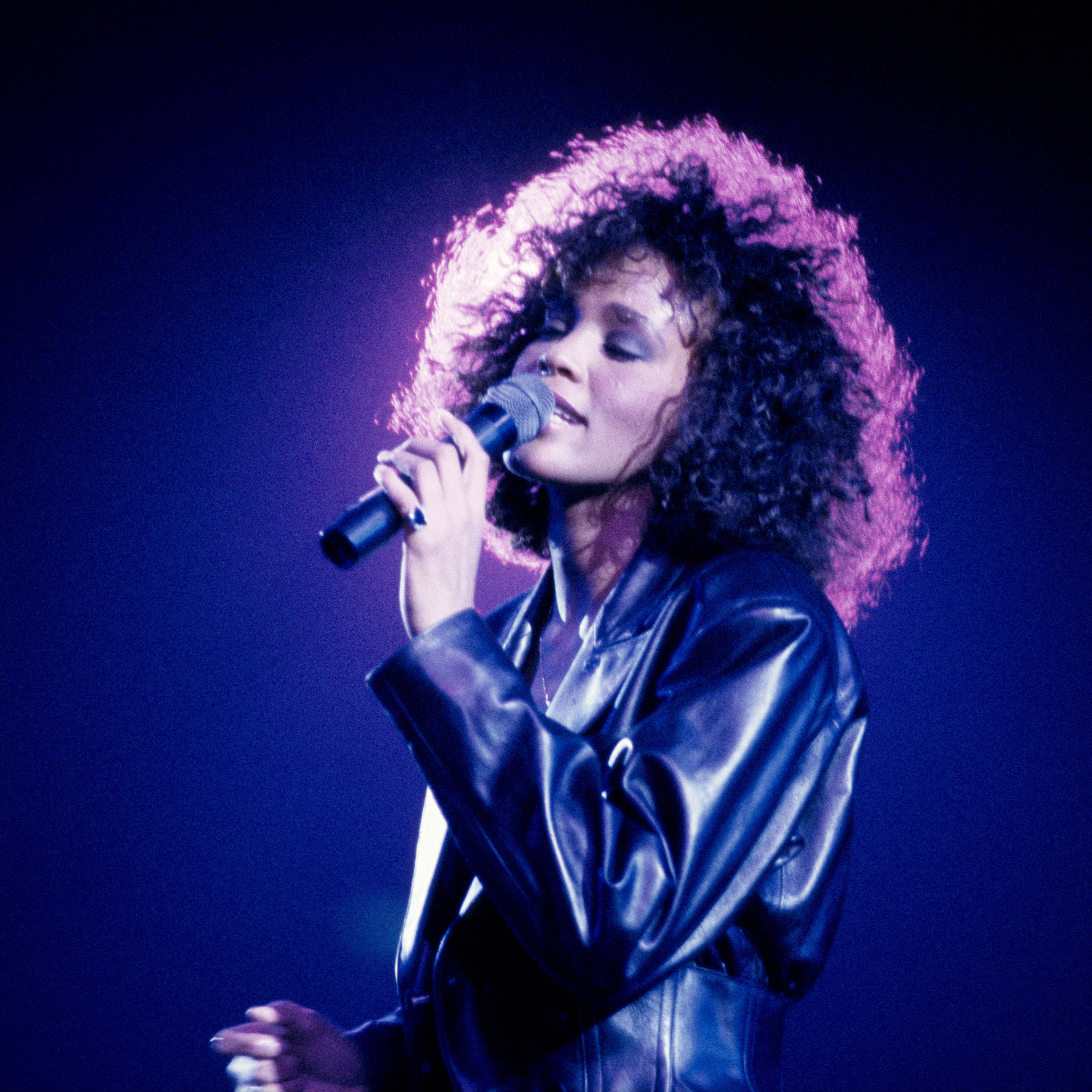 Whitney Houston, black leather jacket, purple light, 2K Phone Wallpaper