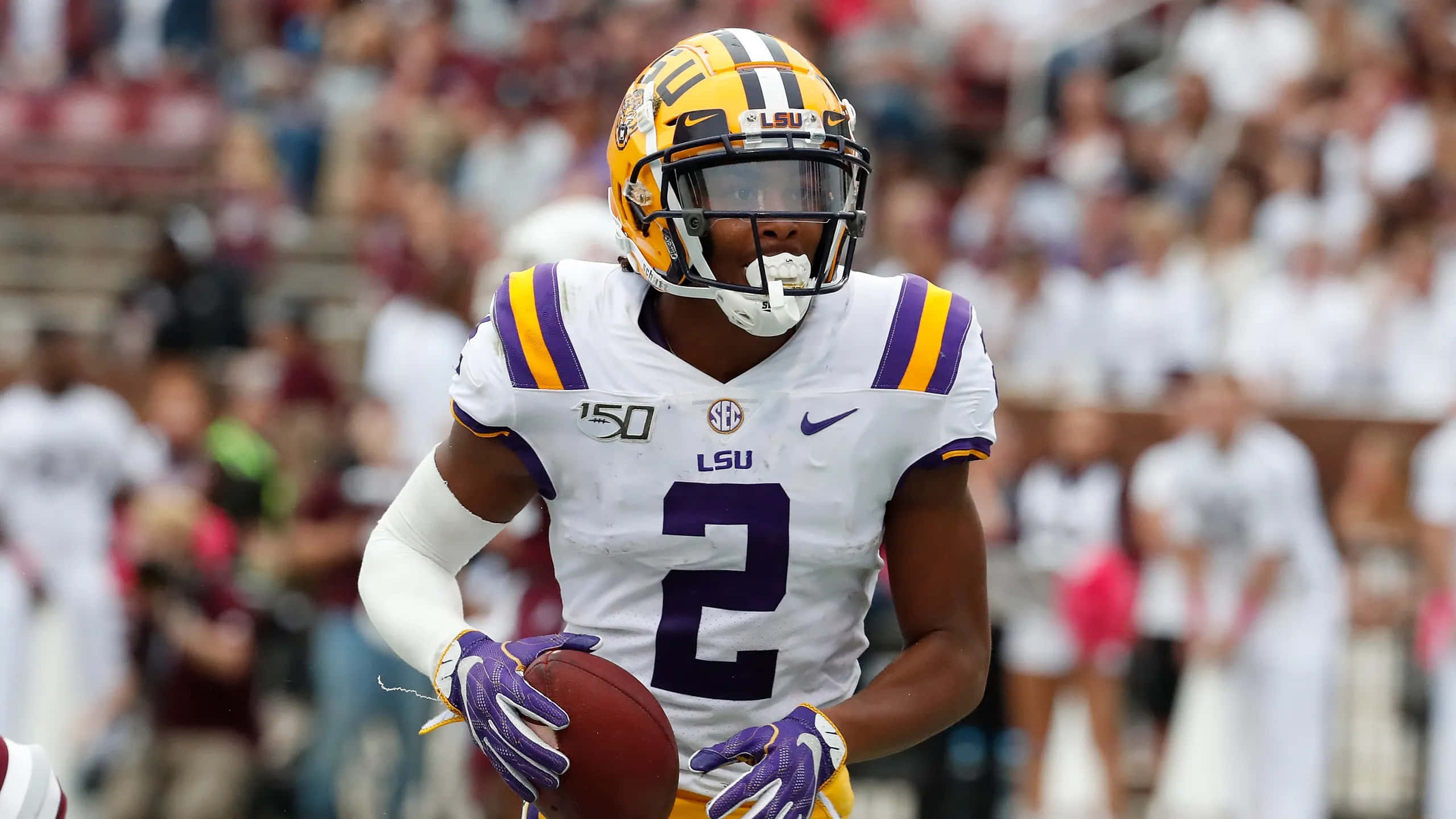 LSU football player, white and purple gear, daytime game, 2K Desktop Wallpaper