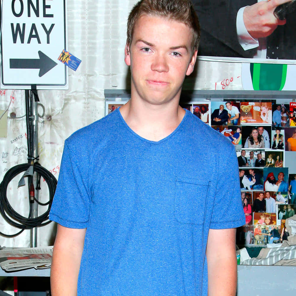 Will Poulter, blue t-shirt, wall covered with photos, SD Desktop Wallpaper