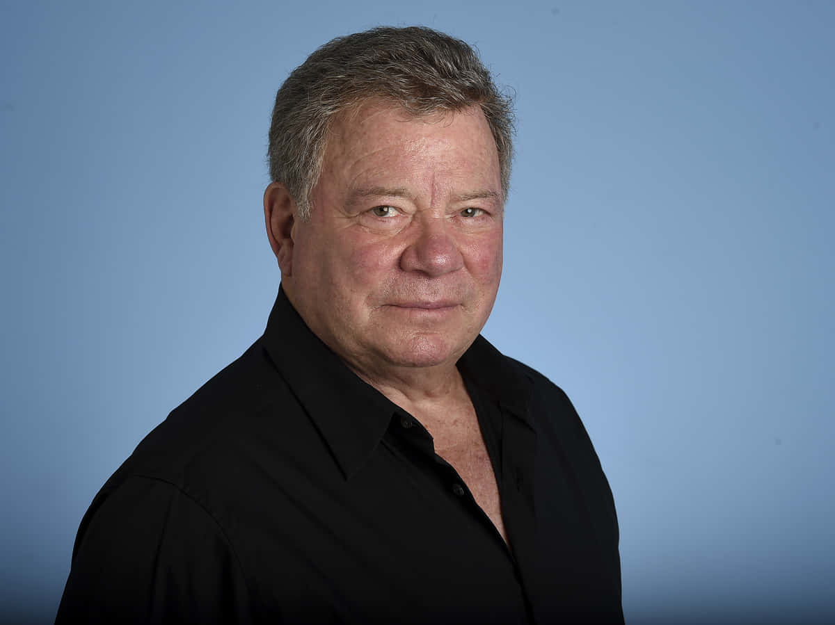 William Shatner, black shirt, solid blue studio background, SD Desktop Wallpaper