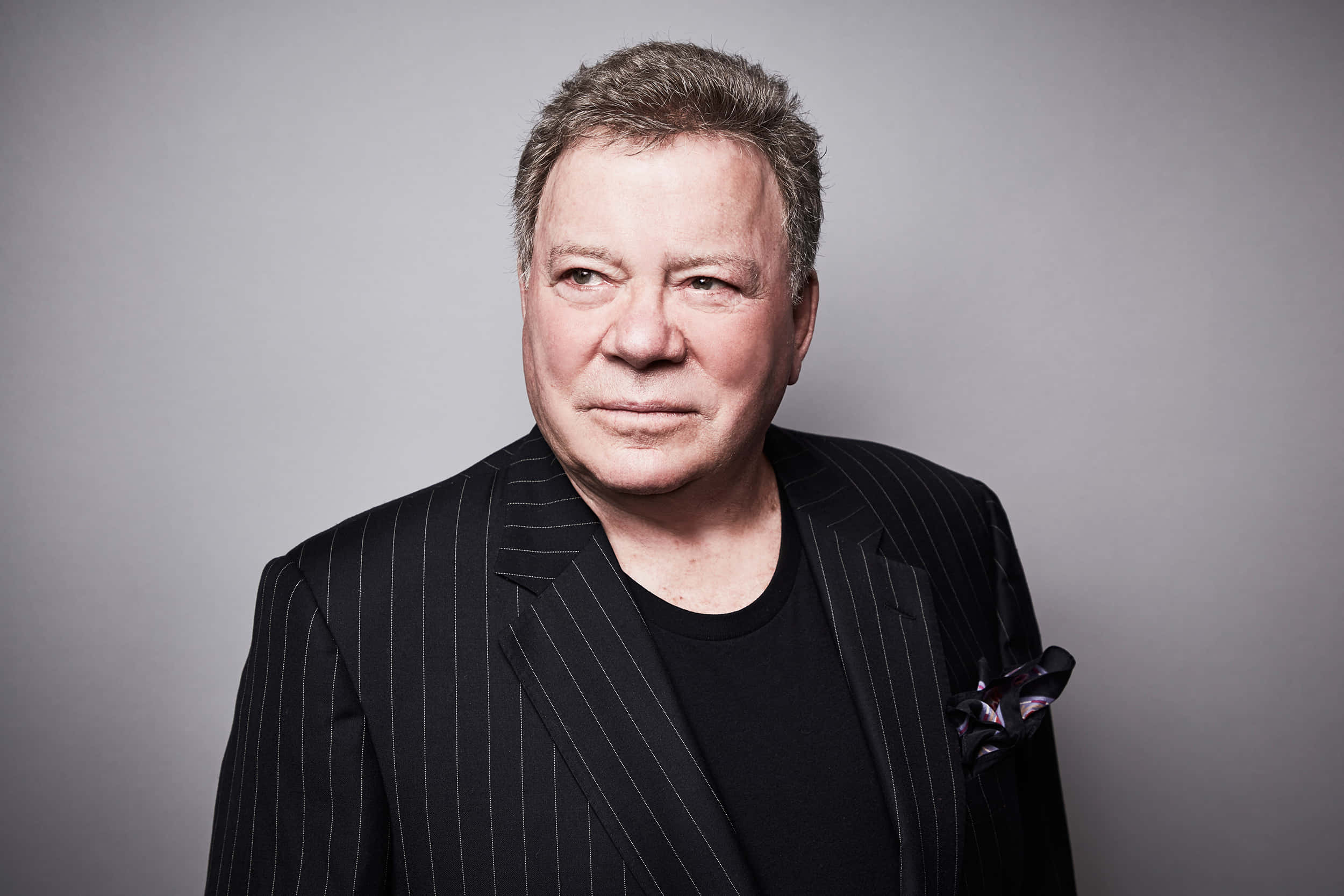 William Shatner, black pinstripe suit, plain gray background, Full HD Desktop Wallpaper