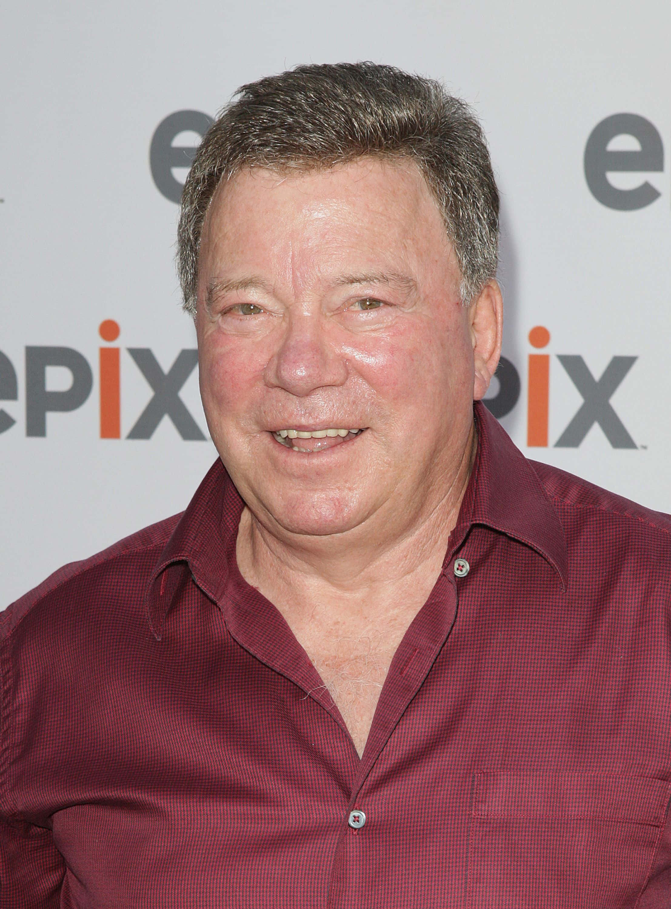 William Shatner, maroon checkered shirt, white Epix branded backdrop, 2K Phone Wallpaper