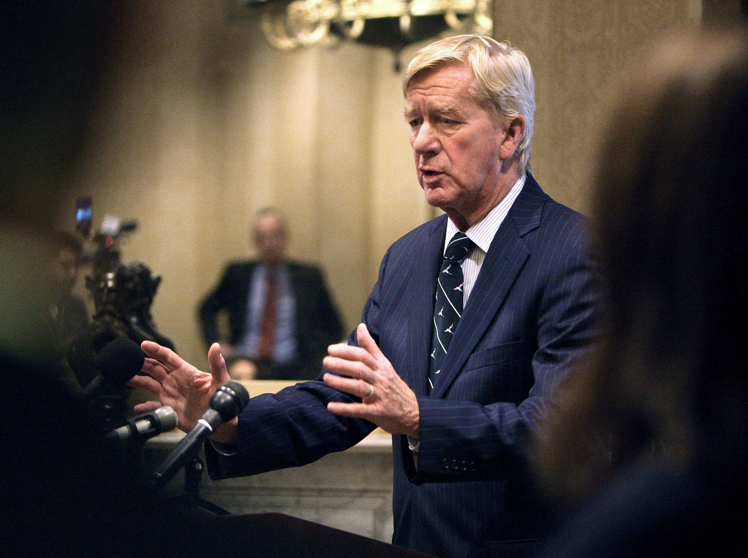 William Weld, dark pinstripe suit, podium, 2K Desktop Wallpaper