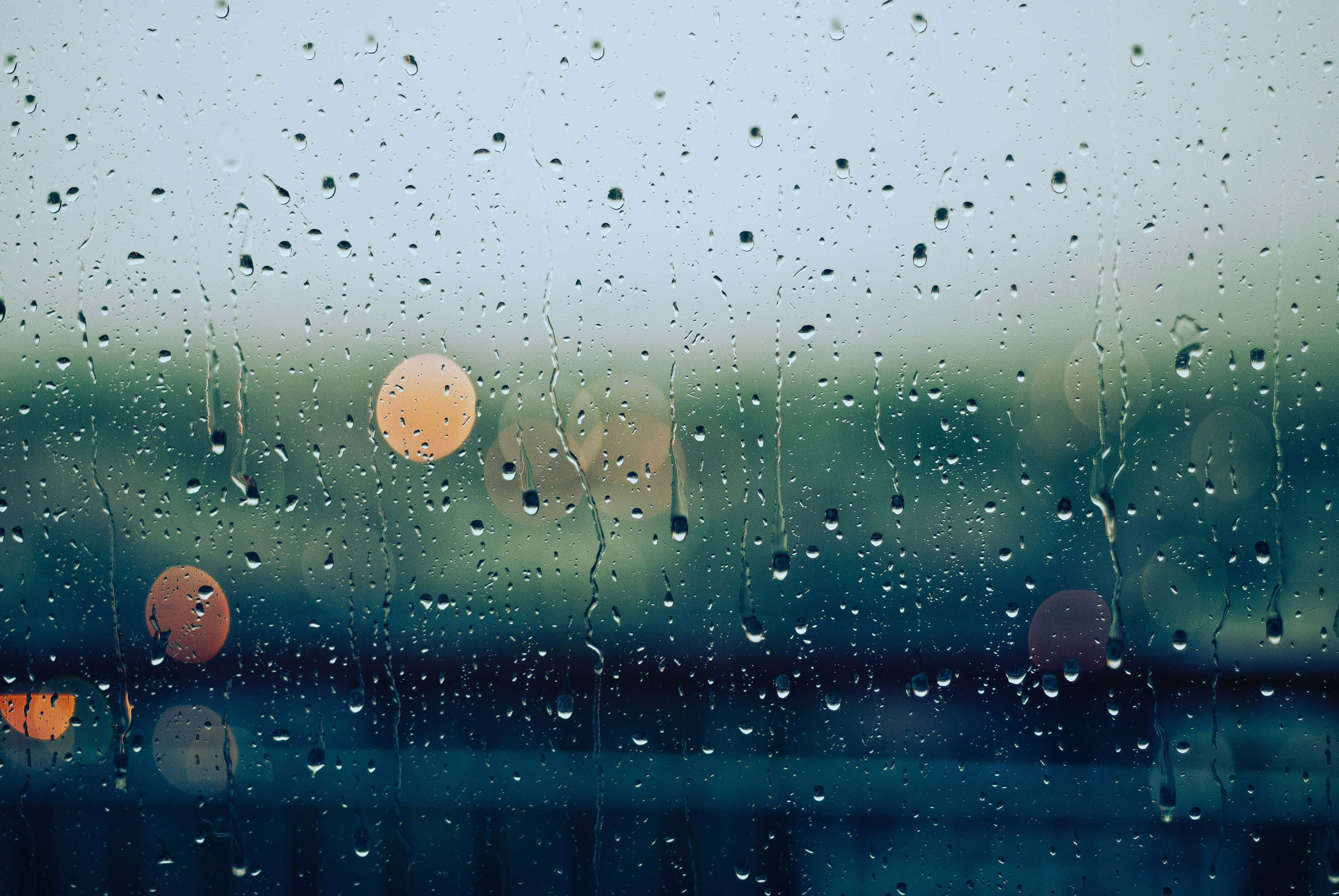 raindrops, blurry car window, orange lights, 2K Desktop Wallpaper