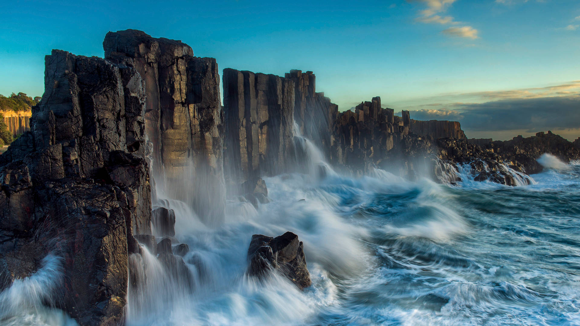 Windows Lock Screen Display, ocean waves, towering dark basalt columns, Full HD Desktop Wallpaper