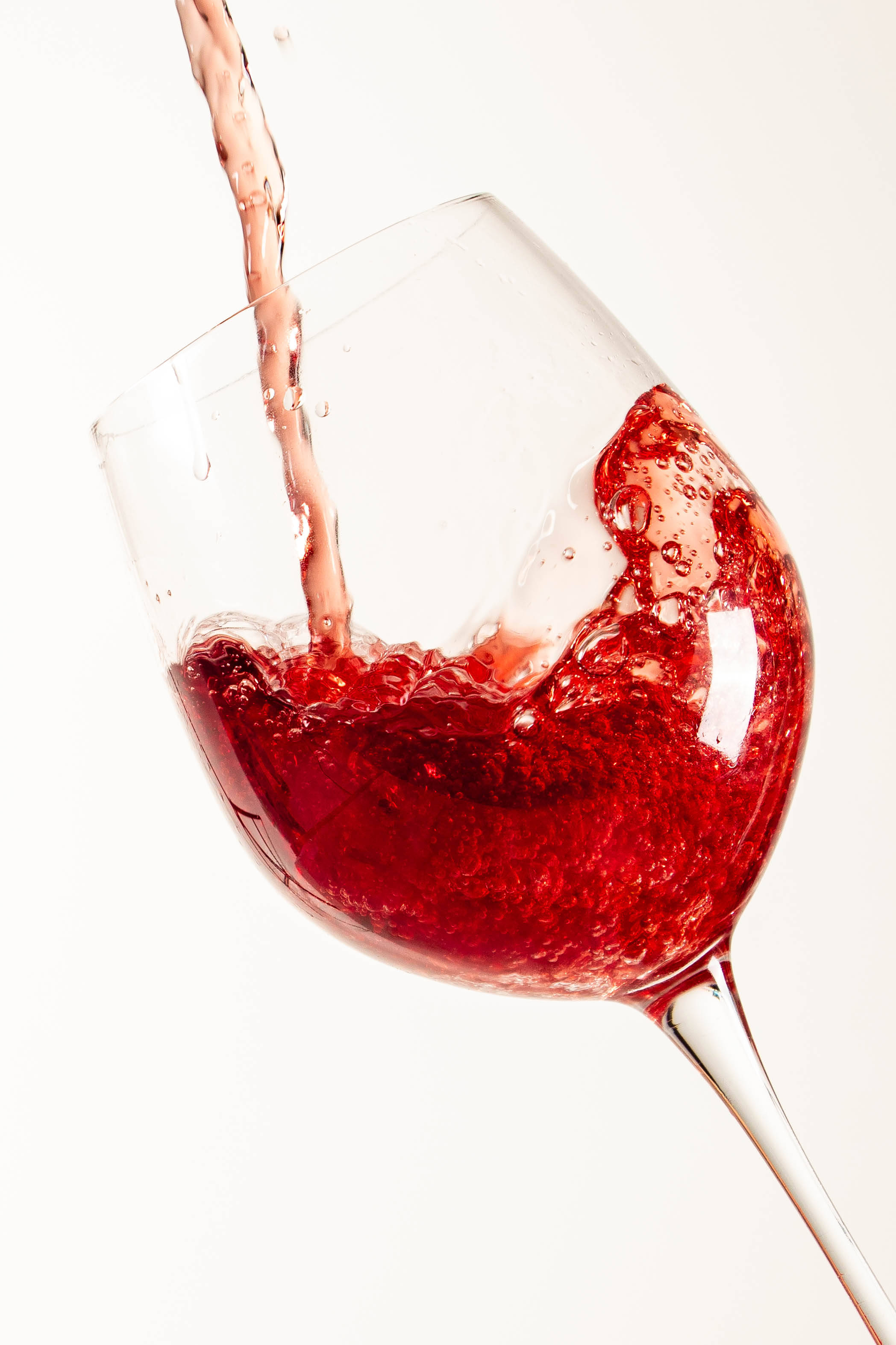 sparkling red wine, clear glass, stark white background, 2K Phone Wallpaper