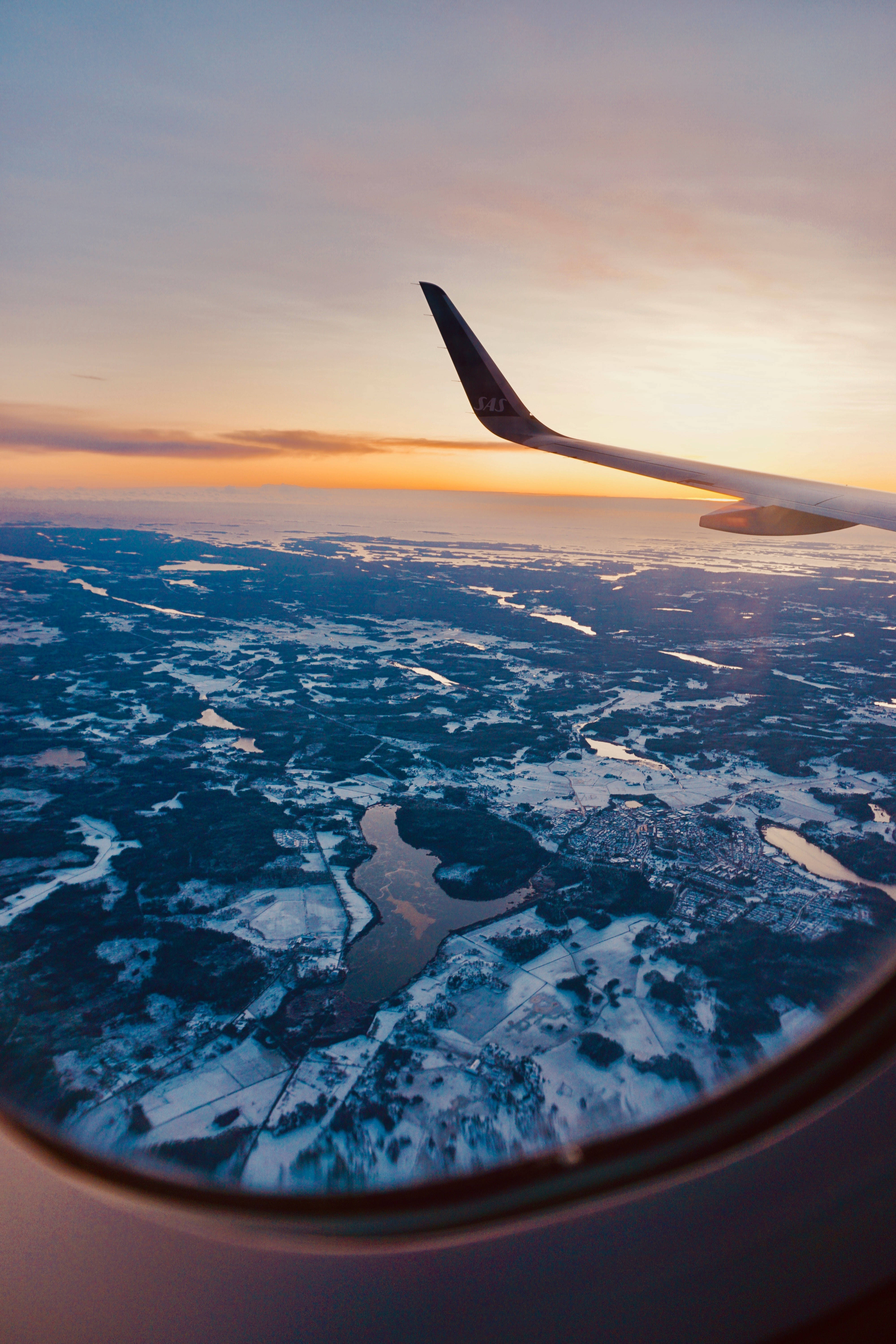aircraft wing silhouette, golden sunset, snow-dusted landscape, 5K Phone Wallpaper
